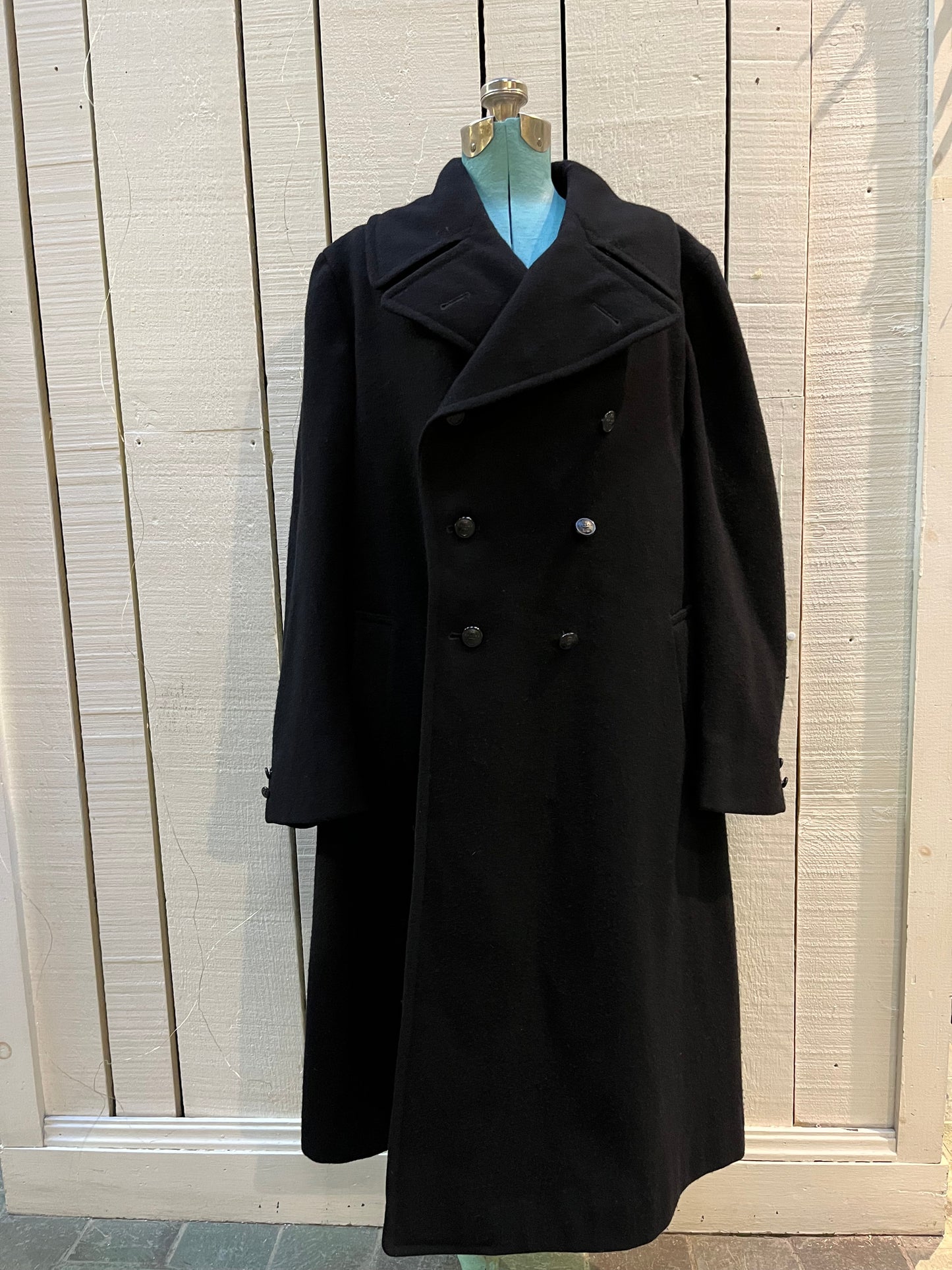 Vintage black 100% wool double breasted long naval uniform coat by Cowell Prince Pants and Clothing Co. with partial lining, two front pockets and two inside pockets.
Size 2, chest 44”