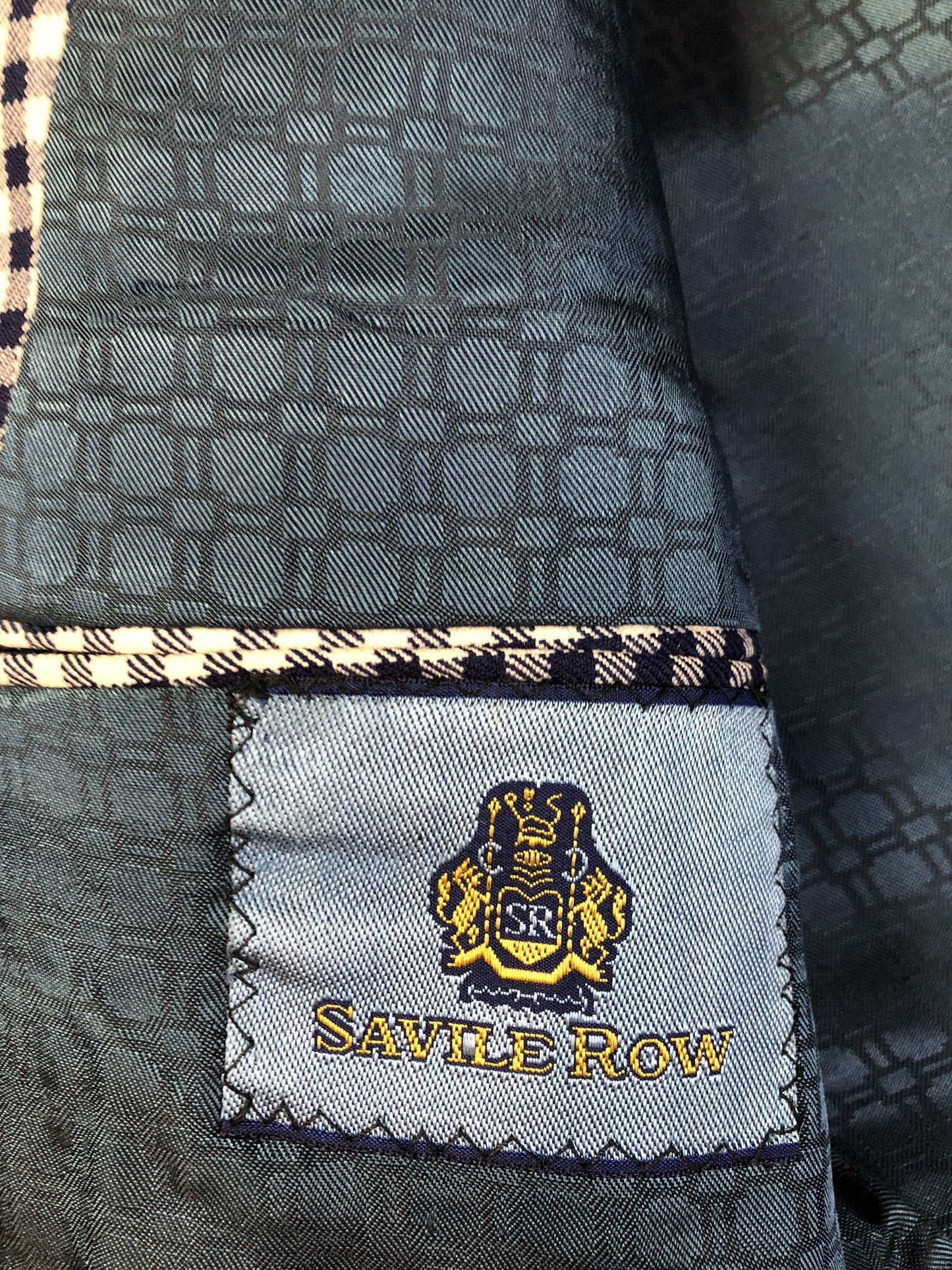 Vintage Saville Row two piece suit in navy and white gingham pattern is union made. Jacket is a two button, notch lapel with two flap pockets in the front, one breast pocket and two inside pockets. Trousers feature a mid rise, wide leg, pressed crease and two front and back pockets.38”x28.5” - Kingspier VintageVintage Saville Row two piece suit in navy and white gingham pattern is union made. - Kingspier vintage