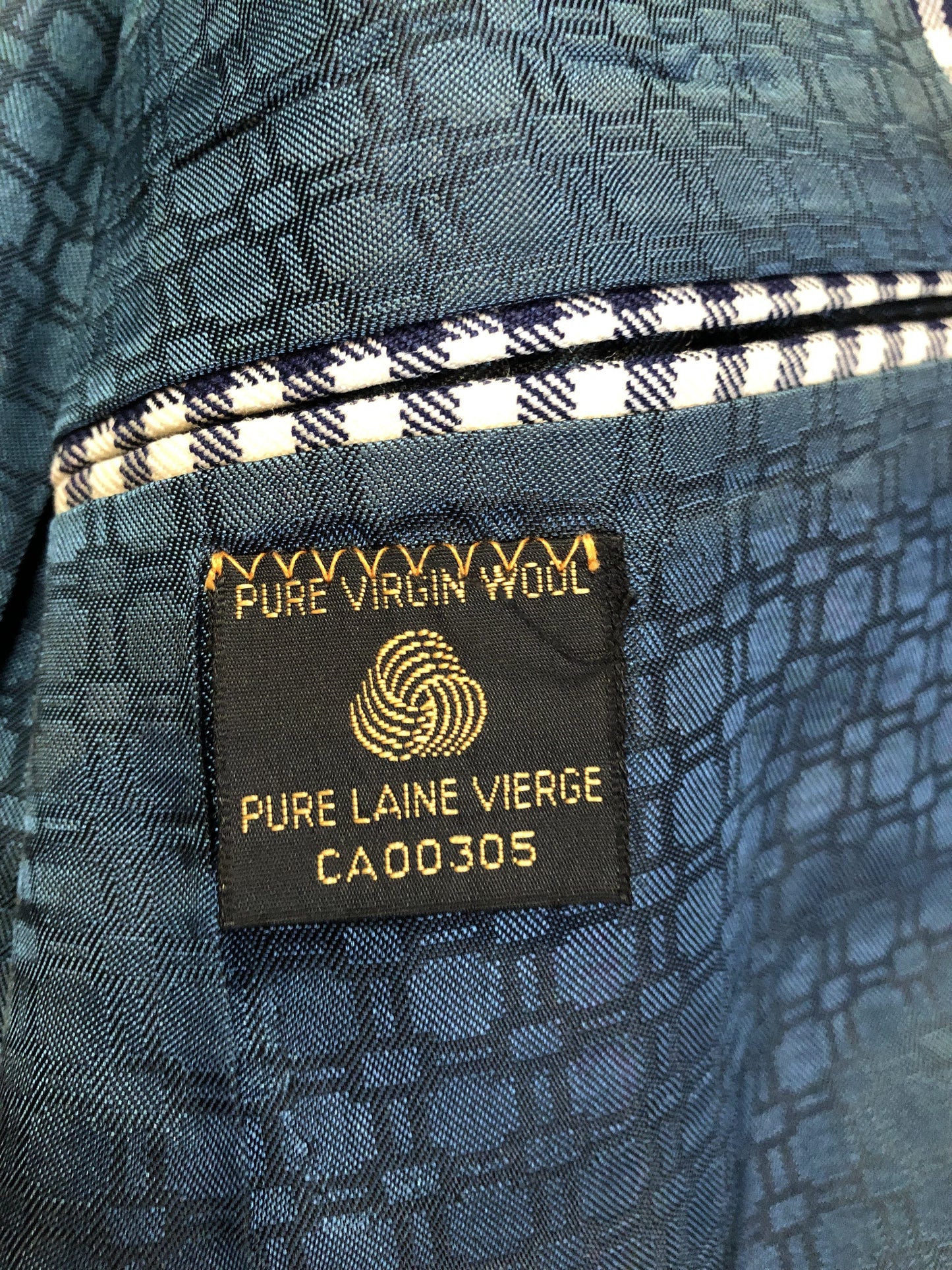 Vintage Saville Row two piece suit in navy and white gingham pattern is union made. Jacket is a two button, notch lapel with two flap pockets in the front, one breast pocket and two inside pockets. Trousers feature a mid rise, wide leg, pressed crease and two front and back pockets.38”x28.5” - Kingspier Vintage