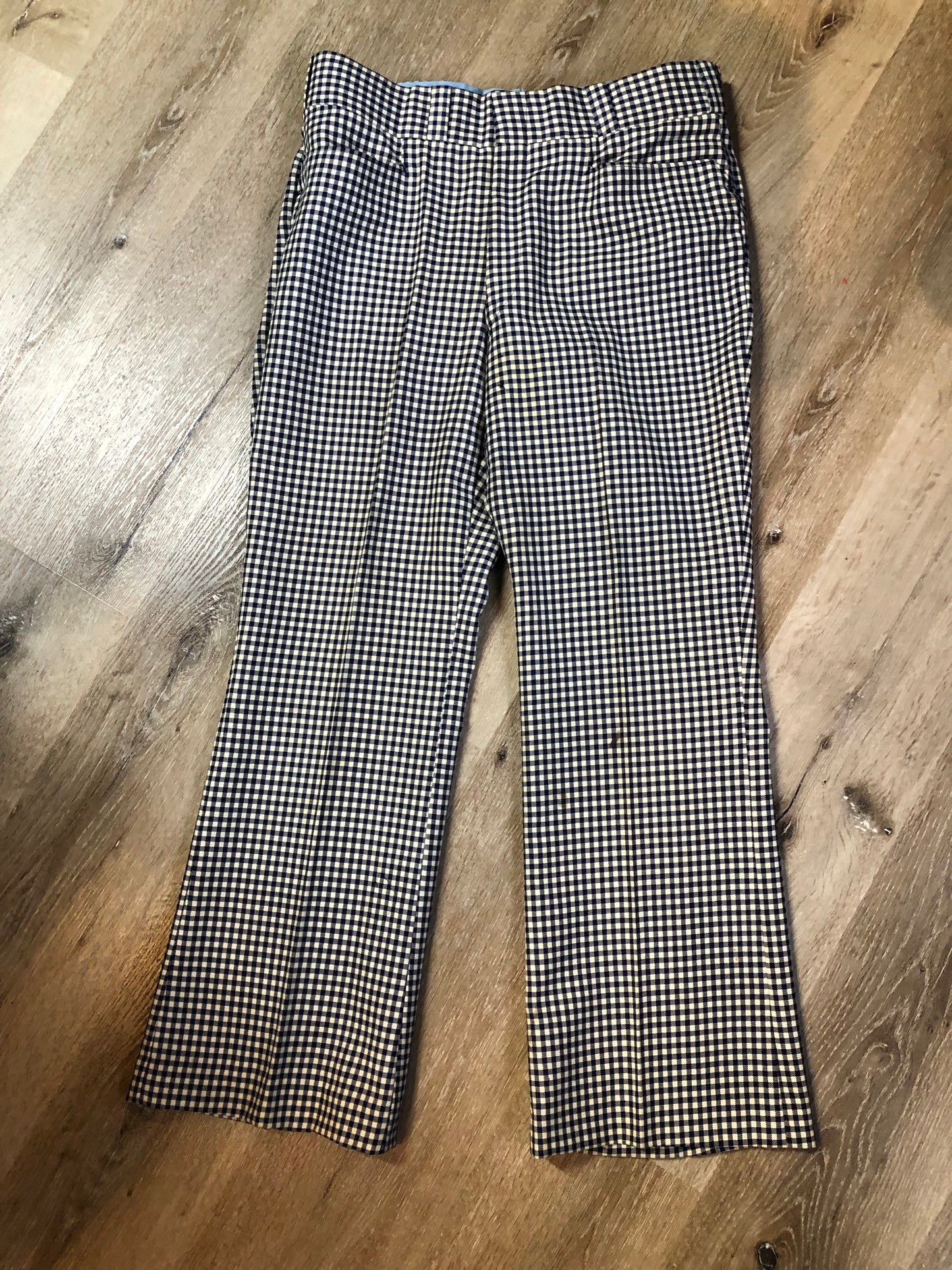 Vintage Saville Row two piece suit in navy and white gingham pattern is union made. Jacket is a two button, notch lapel with two flap pockets in the front, one breast pocket and two inside pockets. Trousers feature a mid rise, wide leg, pressed crease and two front and back pockets.38”x28.5” - Kingspier Vintage