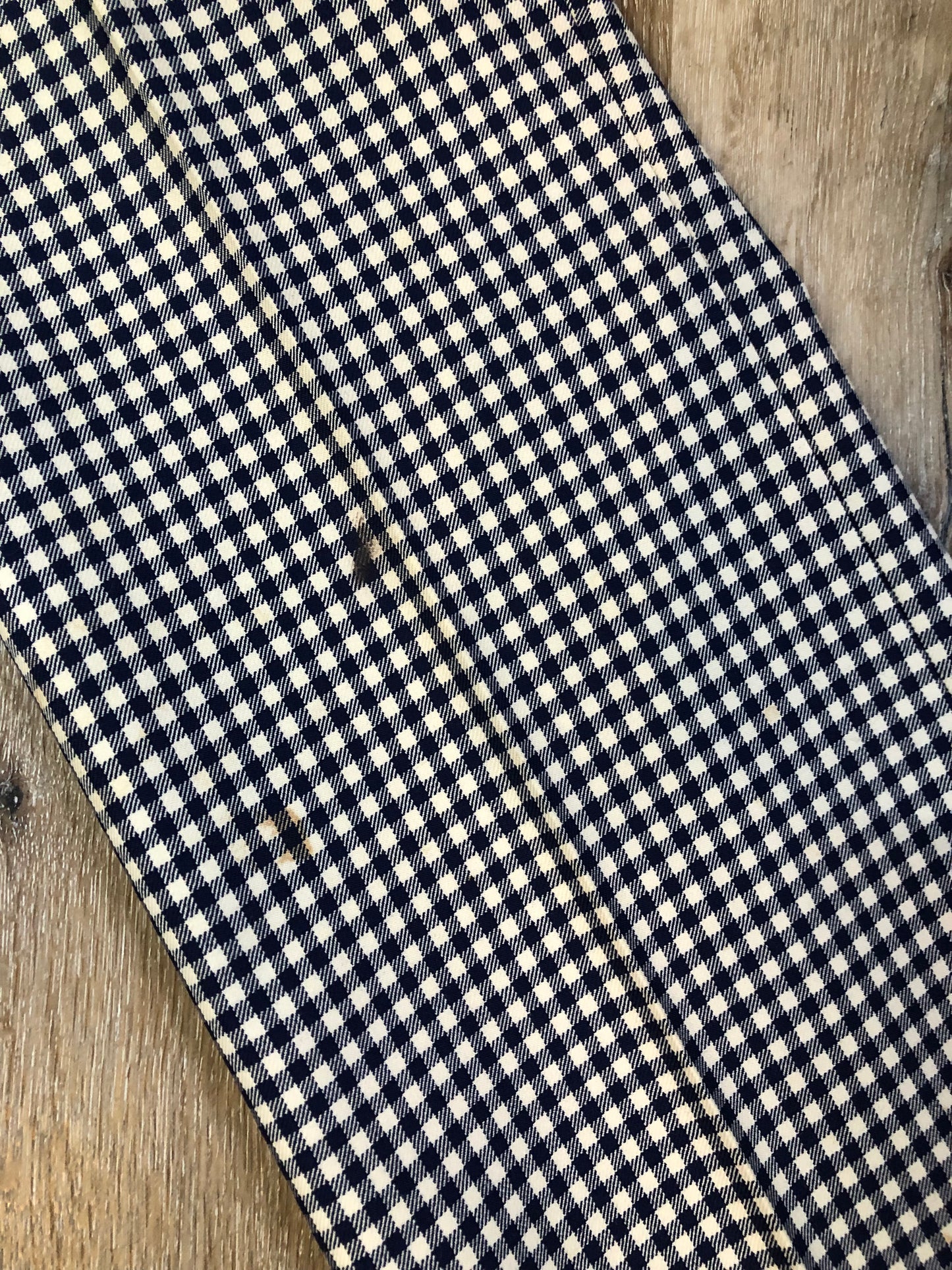 Vintage Saville Row two piece suit in navy and white gingham pattern is union made. Jacket is a two button, notch lapel with two flap pockets in the front, one breast pocket and two inside pockets. Trousers feature a mid rise, wide leg, pressed crease and two front and back pockets.38”x28.5” - Kingspier Vintage