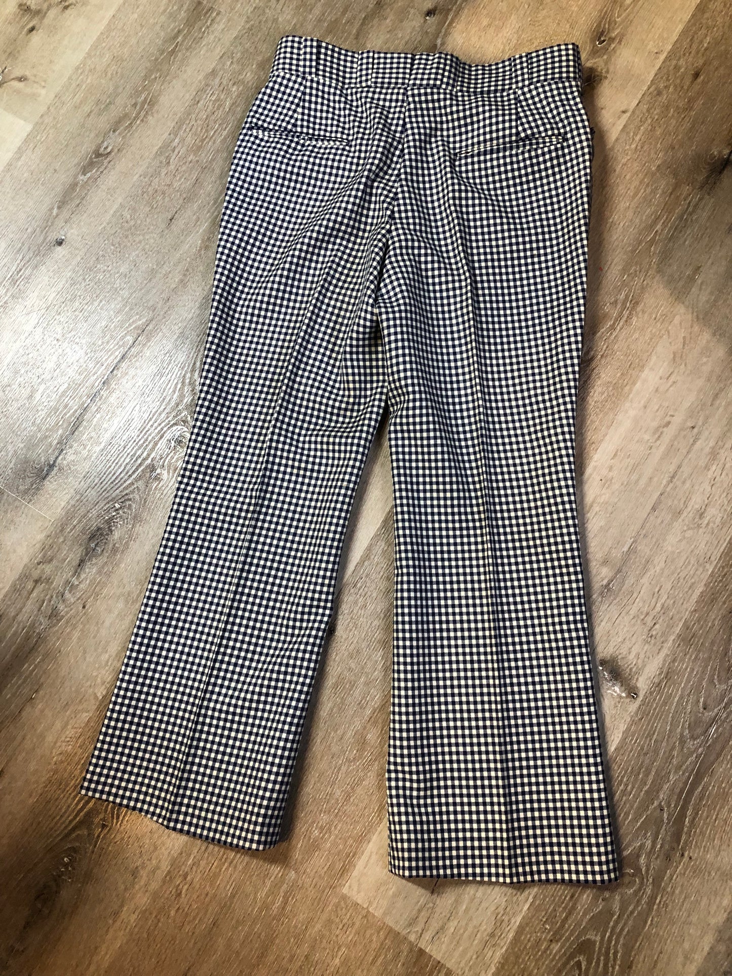 Vintage Saville Row two piece suit in navy and white gingham pattern is union made. Jacket is a two button, notch lapel with two flap pockets in the front, one breast pocket and two inside pockets. Trousers feature a mid rise, wide leg, pressed crease and two front and back pockets.38”x28.5” - Kingspier Vintage