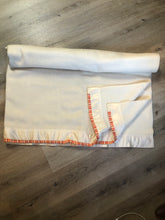 Load image into Gallery viewer, Kingspier Vintage - White 100% wool blanket with white ribbon trim on one end and a red, yellow and orange striped ribbon on the other end.
Fits a double bed.


