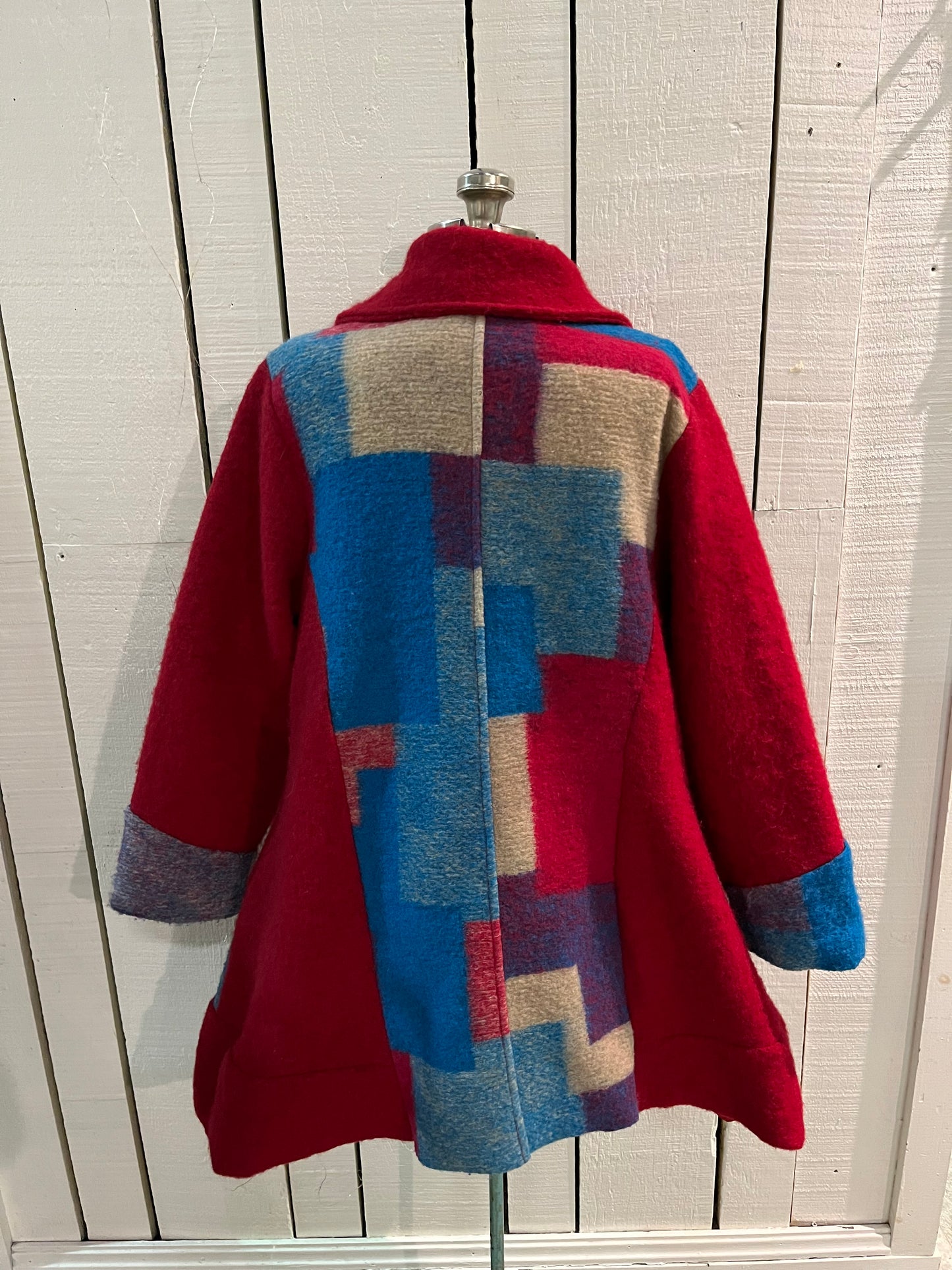 Red and blue wool blend (80% wool/ 20%) patch work coat with matching scarf, toggle closures and two front pockets.
Made in Italy
Chest 43”