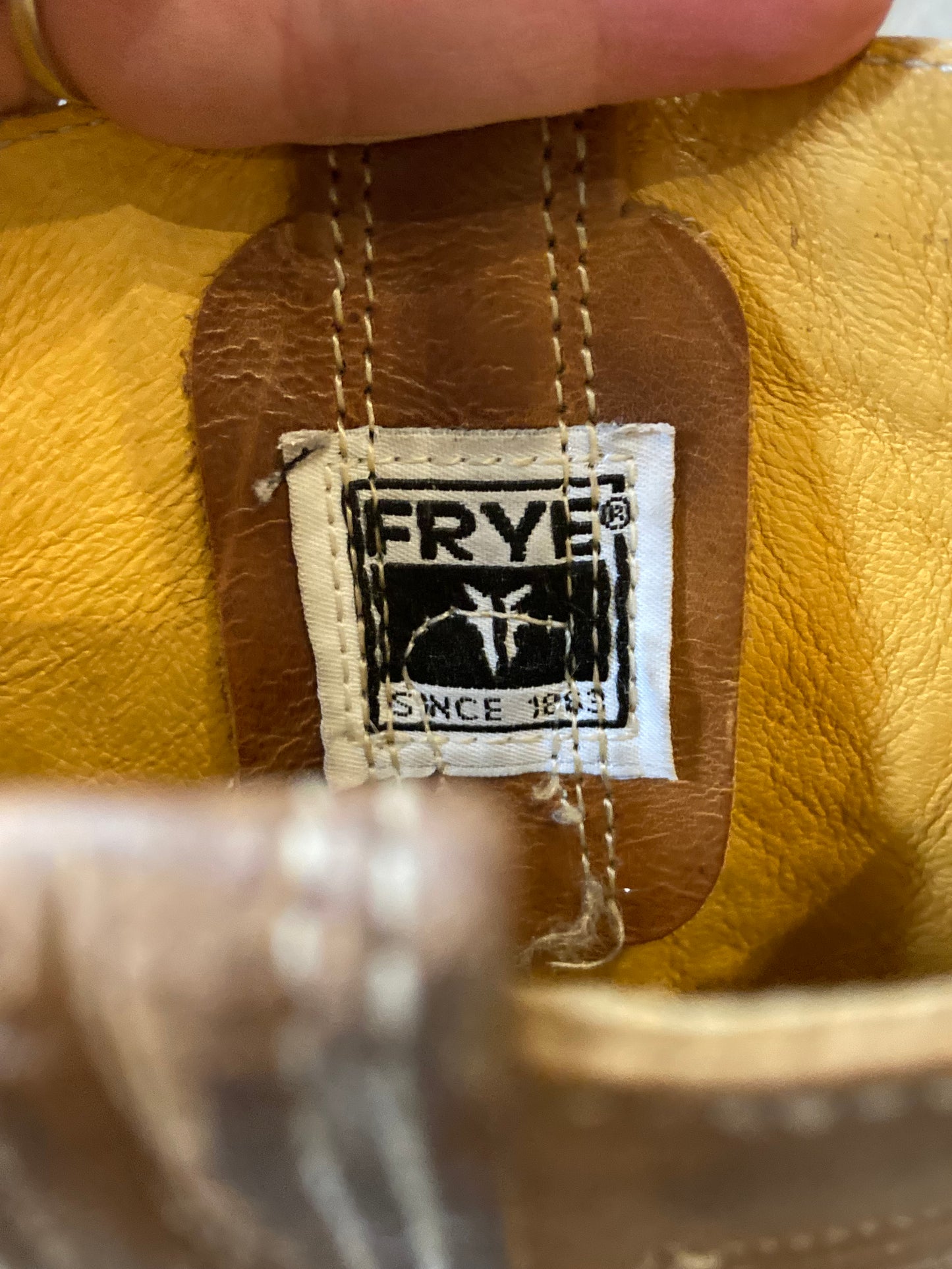 Vintage Frye brown leather western boots with chisel toe, decorative stitching and brass o ring detail. Size 6.5M, 8W US/ 38 EUR
