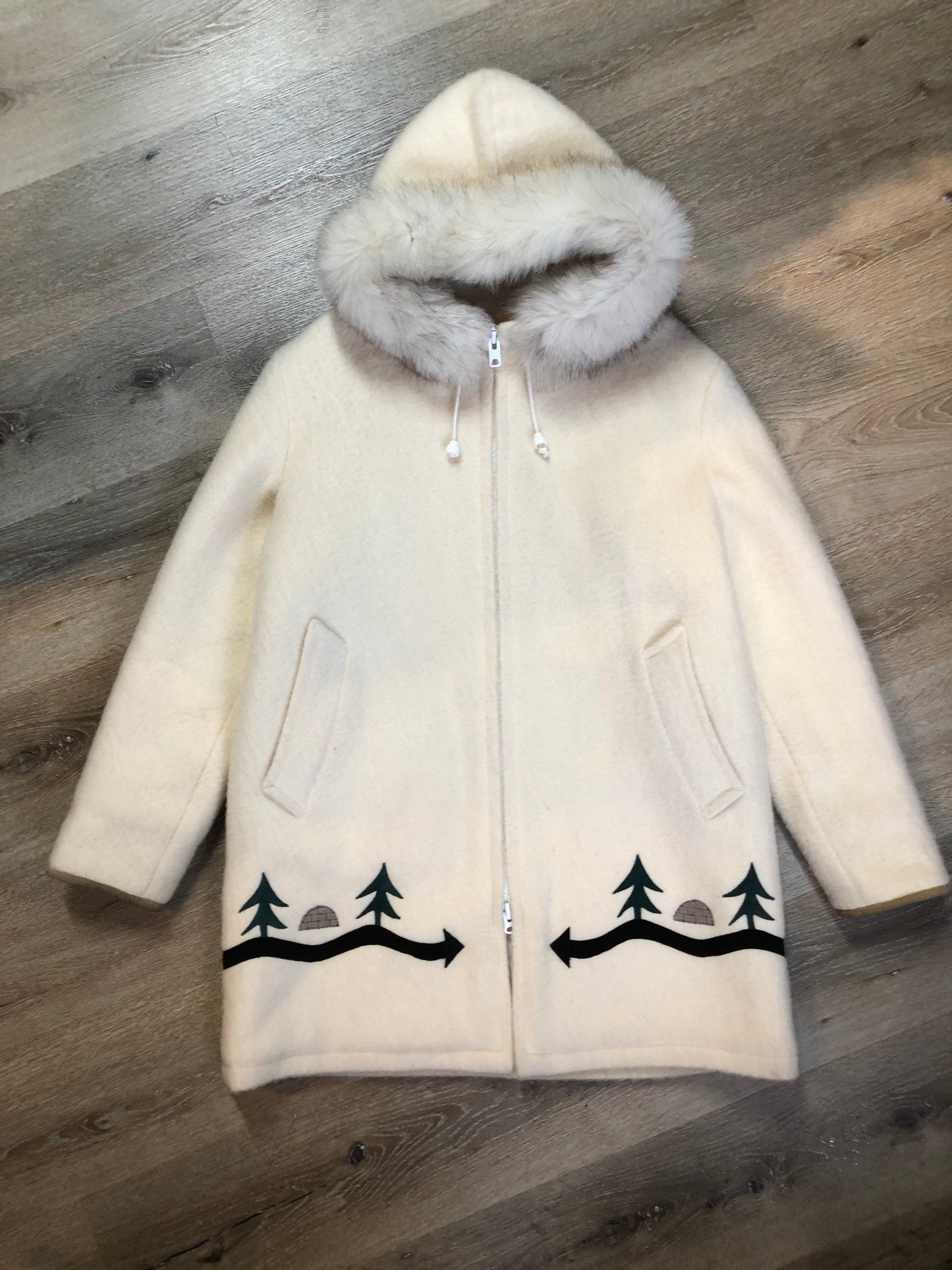 Kingspier Vintage - Hudson’s Bay Company white pure virgin wool northern parka featuring a hood with fox fur trim, zipper closure, quilted lining, inside drawstring, slash pockets, hidden knit cuffs and tree a nd igloo design suede appliqué on the front and back. Made in Canada. Size 14/ large.