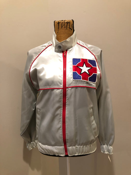 Kingspier Vintage - Milk and Honey - John Lennon and Yoko Ono Roadie Tour Jacket from the mid 1980’s. A very rare collectors piece from John Lennon’s last studio album. Jacket is light grey nylon with satin effect with two slash pockets, elastic waist and cuffs, chunky red zip up front with popper at the collar. The jacket features a star logo on the front and Milk and honey logo on the back with a rainbow. Made in the USA. Size XS.