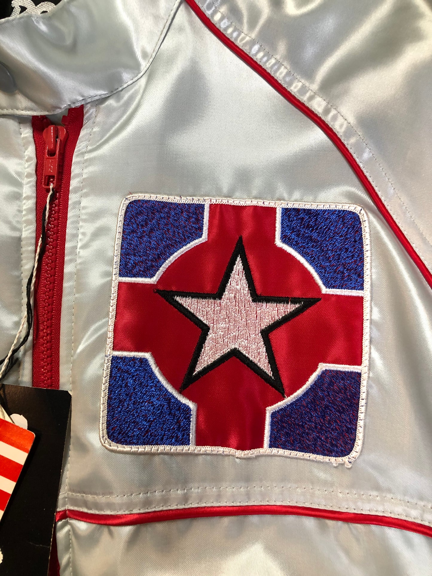 Kingspier Vintage - Milk and Honey - John Lennon and Yoko Ono Roadie Tour Jacket from the mid 1980’s. A very rare collectors piece from John Lennon’s last studio album. Jacket is light grey nylon with satin effect with two slash pockets, elastic waist and cuffs, chunky red zip up front with popper at the collar. The jacket features a star logo on the front and Milk and honey logo on the back with a rainbow. Made in the USA. Size XS.