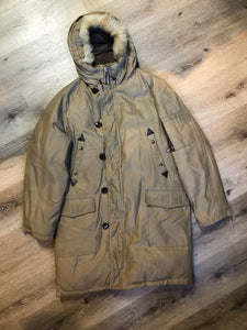 Kingspier Vintage - Richlu down-filled parka in beige with zipper and button closures, fox fur trimmed hood for exceptionally cold conditions. This parka has leather reinforcement details, two flap pockets and two hand warmer pockets with knit inside cuffs and inside drawstring. Made in Winnipeg, Canada. Size large.