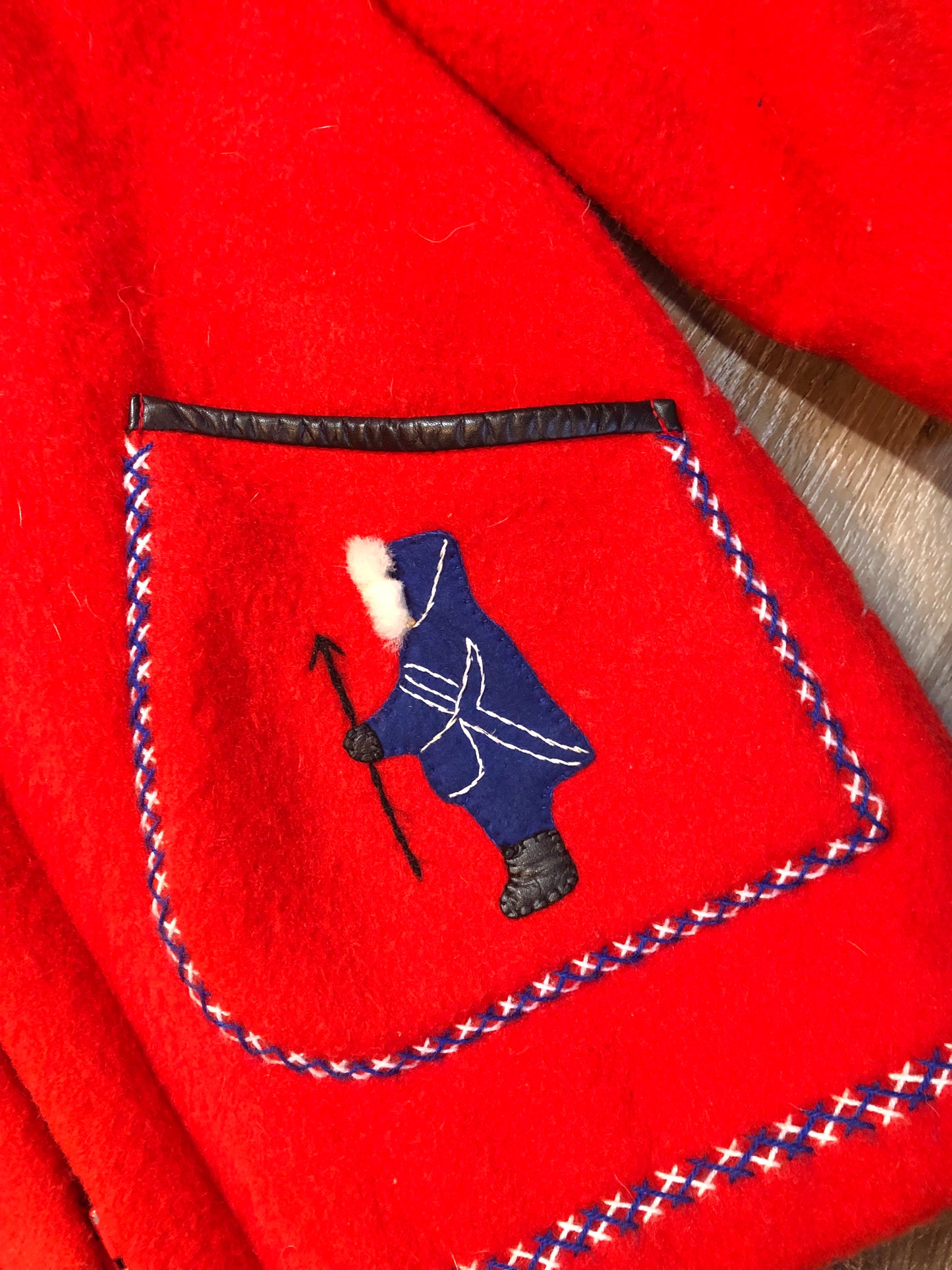 Vintage James Bay 100% virgin wool northern parka in bright red. This parka features a white fur trimmed hood, zipper closure, patch pockets, quilted lining, storm cuffs, embroidery details and northern fishing scene in felt applique. Made in Canada - Kingspier Vintage