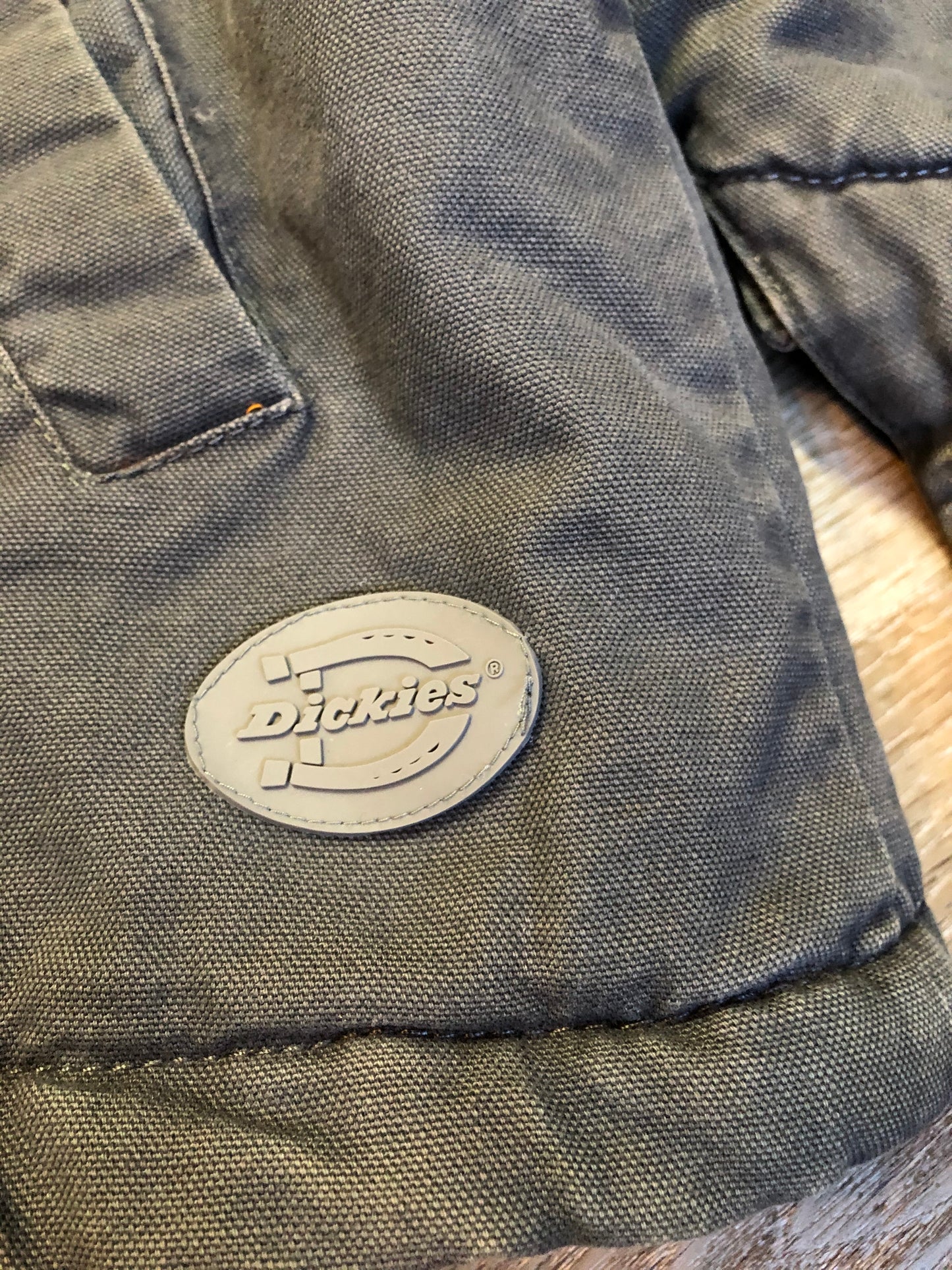 Kingspier Vintage - Dickie’s grey insulted chore jacket with grey corduroy collar, zipper closure, slash pockets, one zip pocket on the chest, one inside pocket and bright orange quilted lining. Size large.