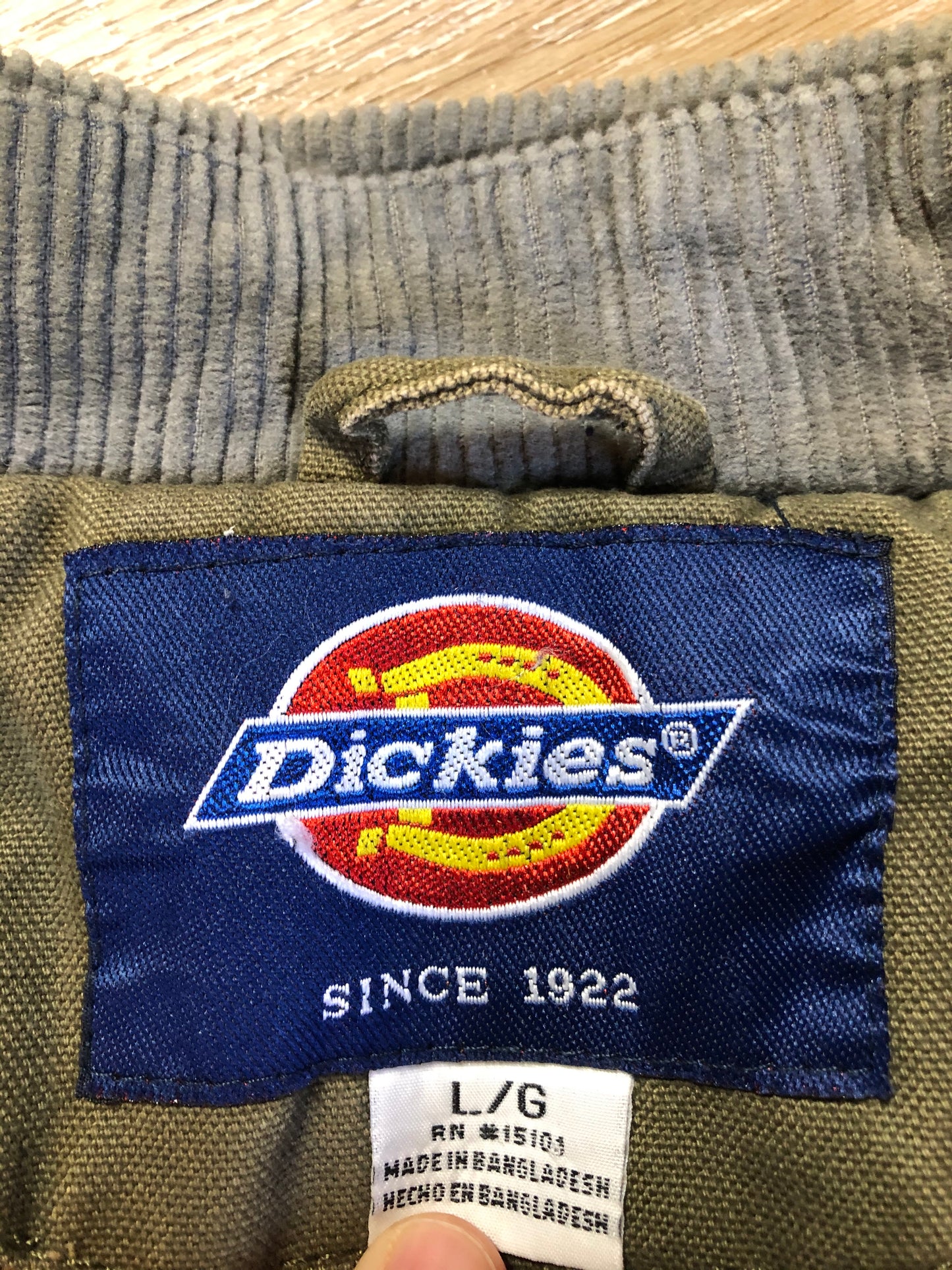 Kingspier Vintage - Dickie’s grey insulted chore jacket with grey corduroy collar, zipper closure, slash pockets, one zip pocket on the chest, one inside pocket and bright orange quilted lining. Size large.