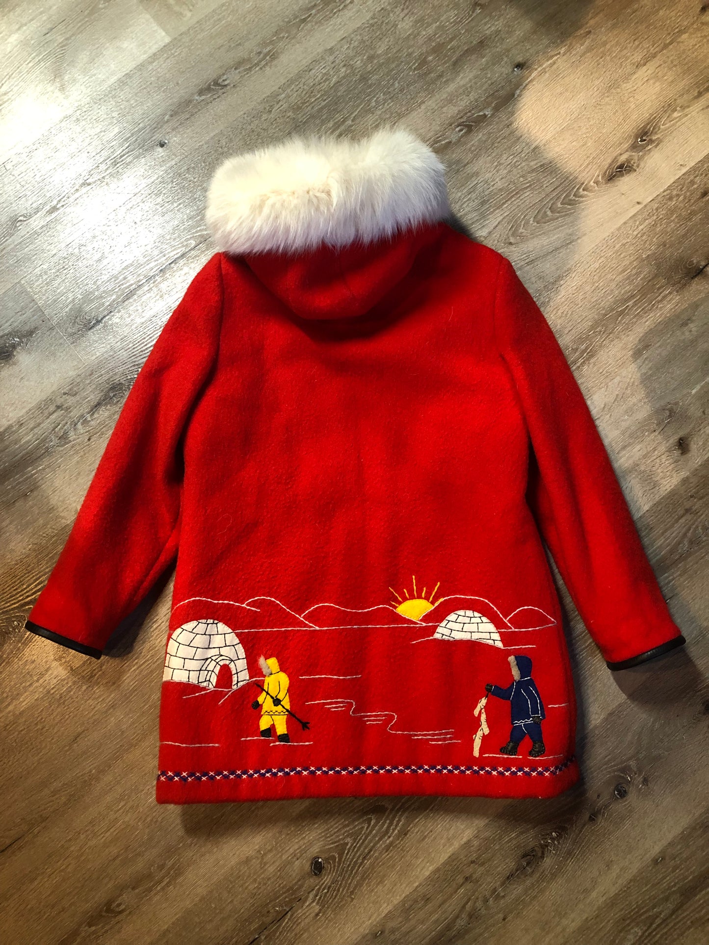 Vintage James Bay 100% virgin wool northern parka in bright red. This parka features a white fur trimmed hood, zipper closure, patch pockets, quilted lining, storm cuffs, embroidery details and northern fishing scene in felt applique. Made in Canada - Kingspier Vintage