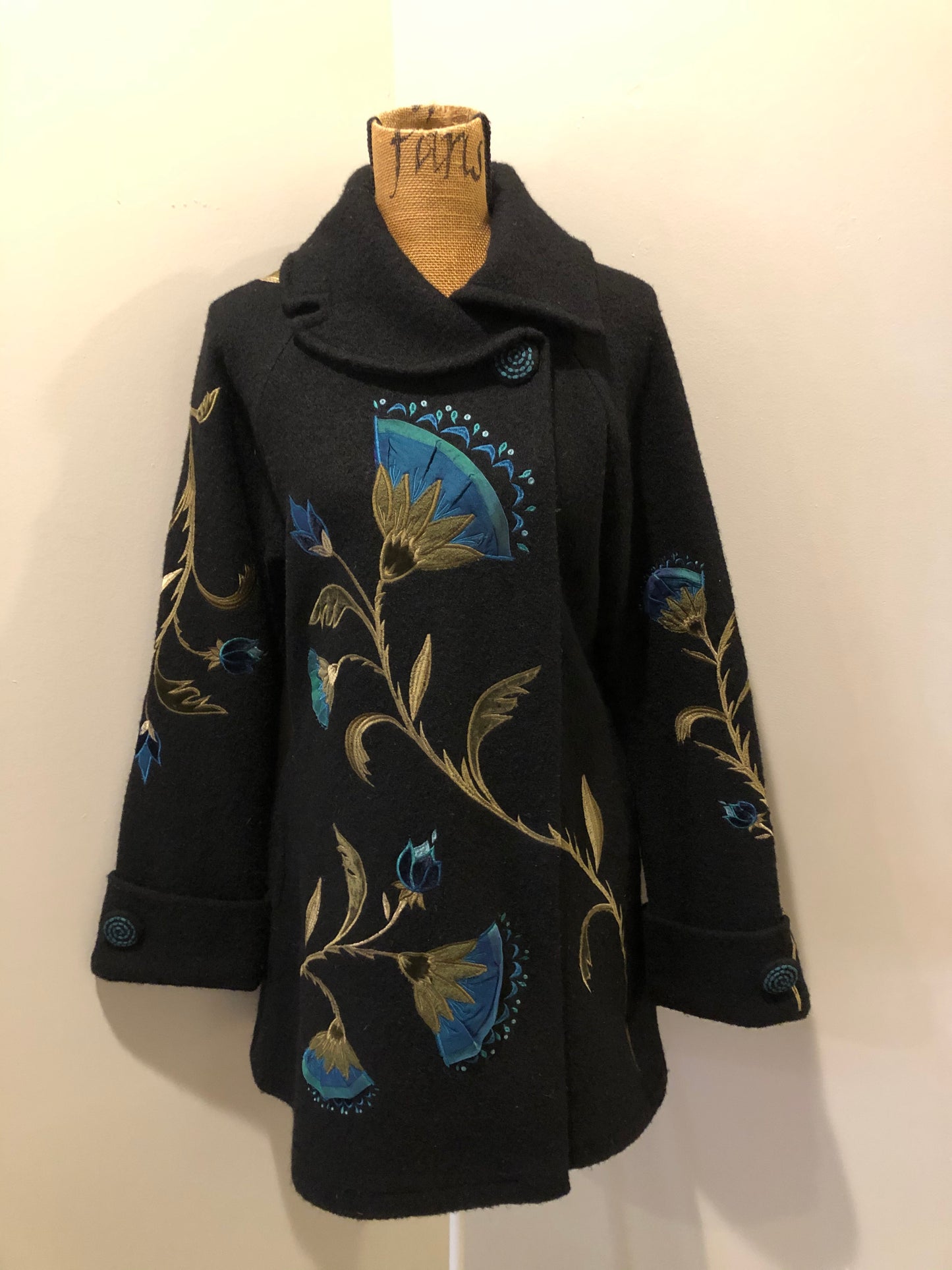 Kingspier Vintage - CoVelo Clothing black wool jacket with flower embellishments. Snap closures, side pockets and embroidered swirl decorative buttons. Size large.