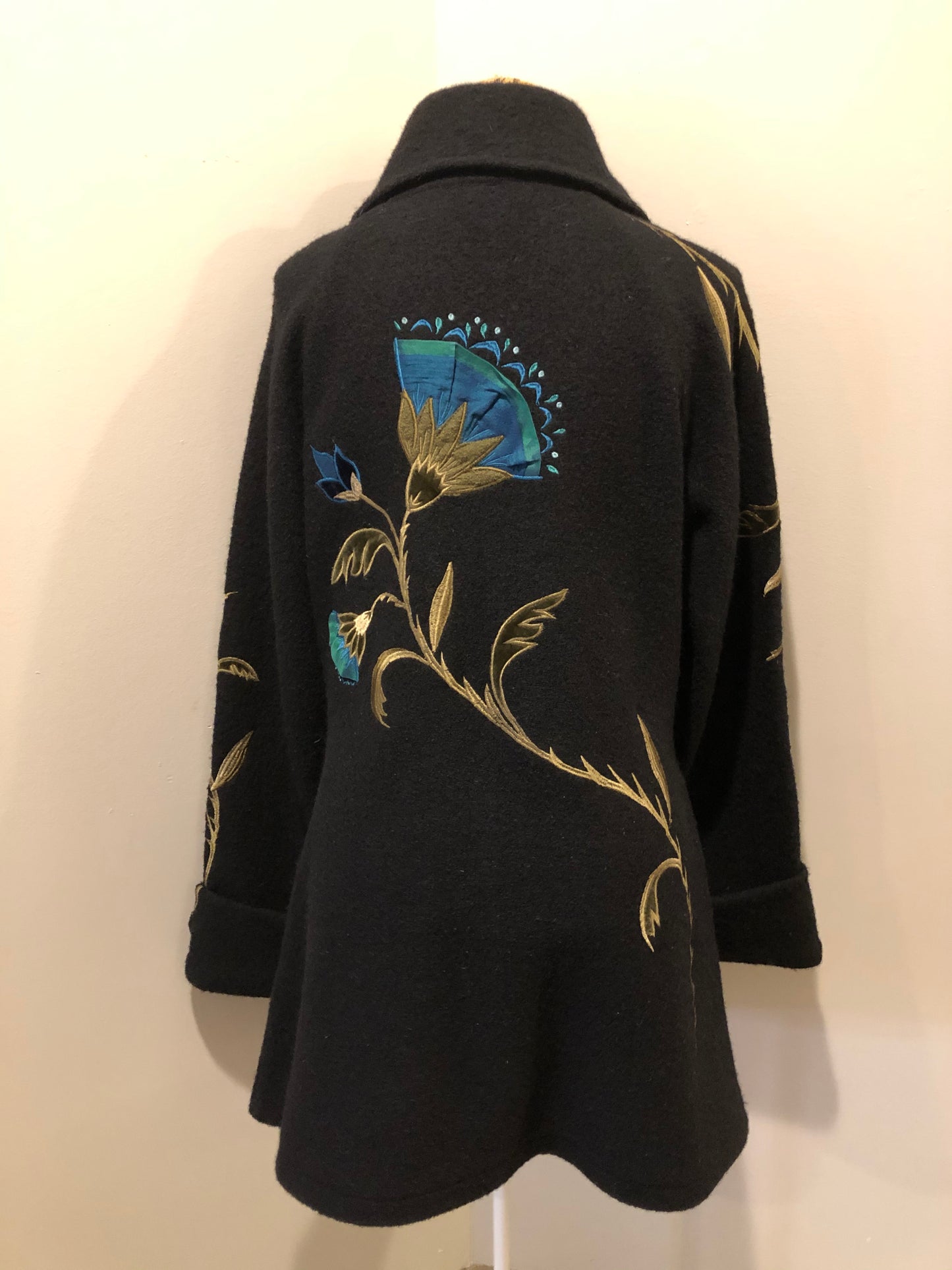 Kingspier Vintage - CoVelo Clothing black wool jacket with flower embellishments. Snap closures, side pockets and embroidered swirl decorative buttons. Size large.