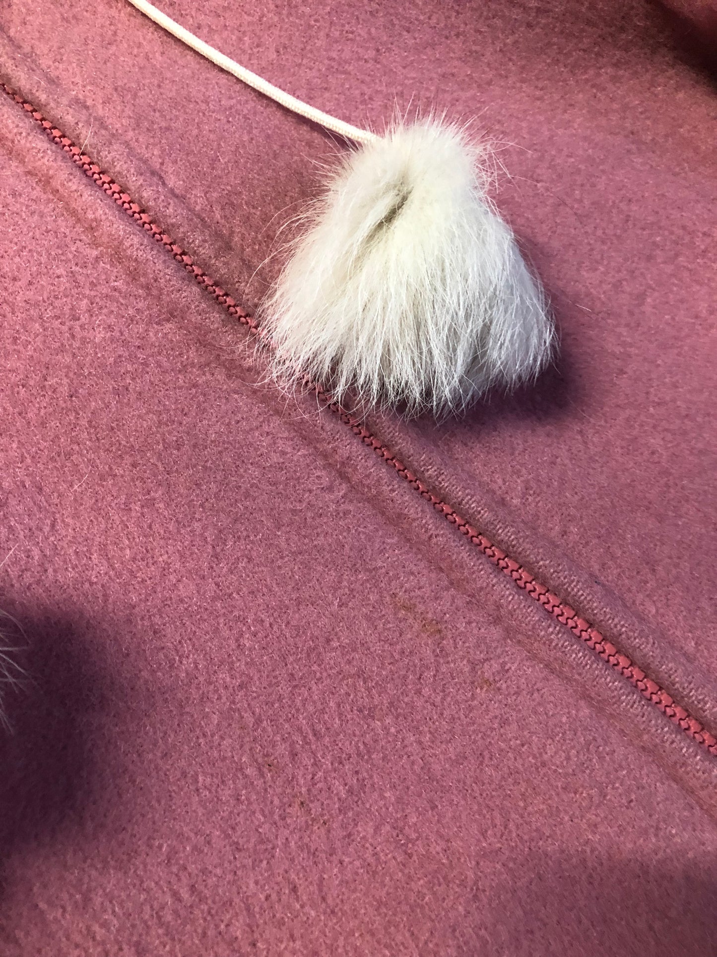 Vintage Hudson’s Bay Company pink 100% virgin wool parka with white fur trimmed hood, fur pom poms, zipper closure, patch pockets, satin lining and embroidered pattern along the hem. Made in Canada. Size 14 - Kingspier Vintage