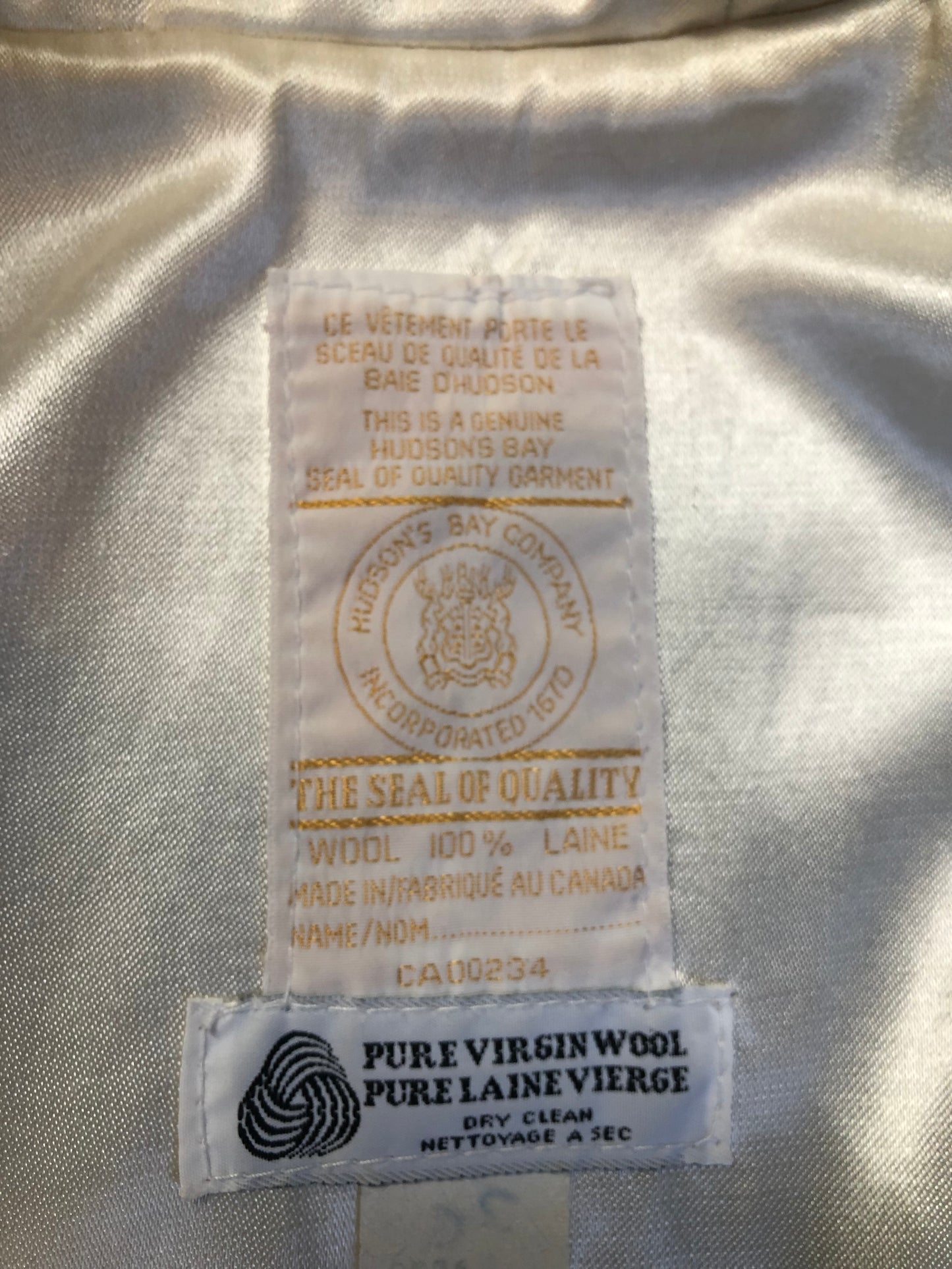 Vintage Hudson’s Bay Company pink 100% virgin wool parka with white fur trimmed hood, fur pom poms, zipper closure, patch pockets, satin lining and embroidered pattern along the hem. Made in Canada. Size 14 - Kingspier Vintage