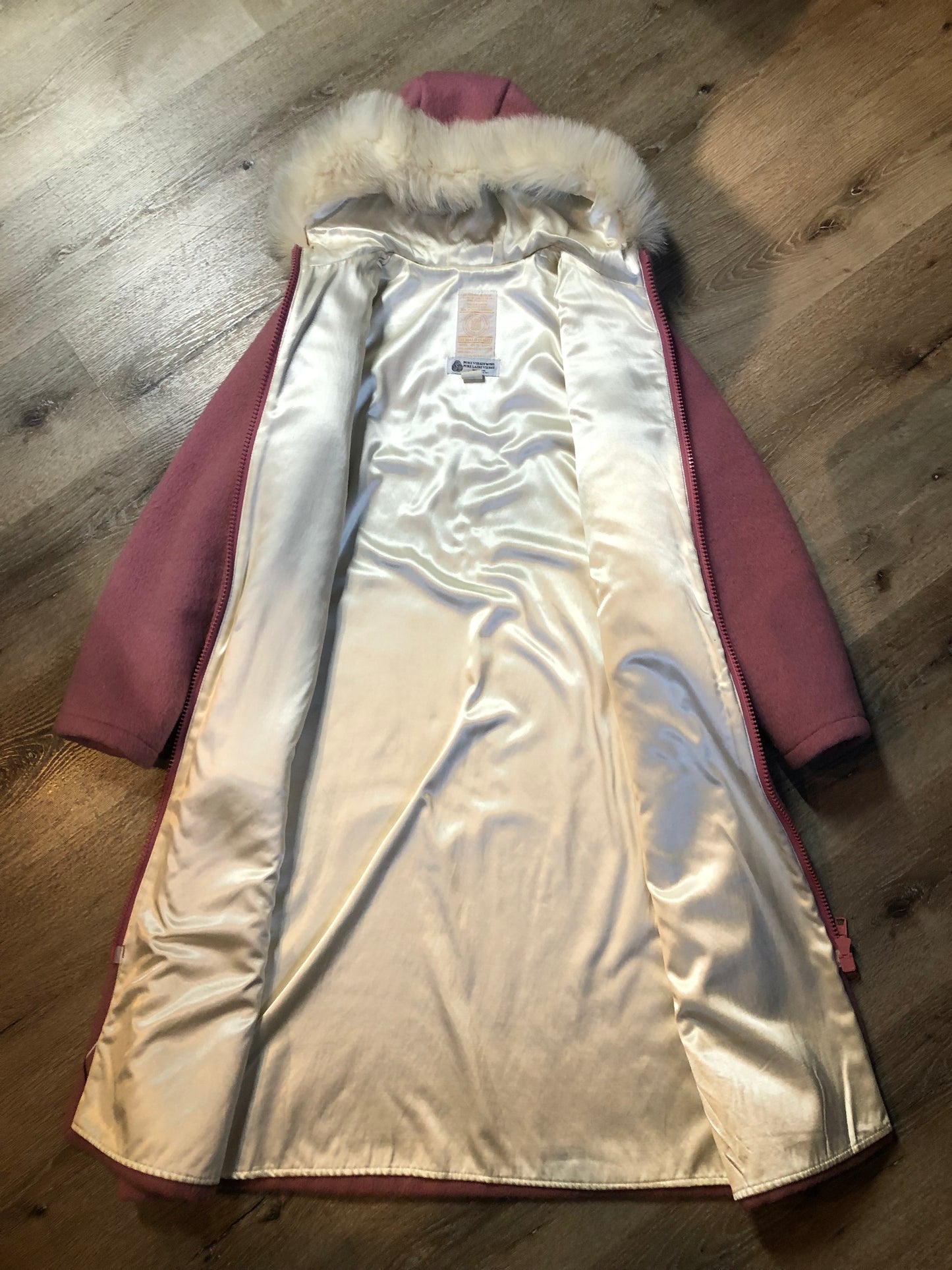 Vintage Hudson’s Bay Company pink 100% virgin wool parka with white fur trimmed hood, fur pom poms, zipper closure, patch pockets, satin lining and embroidered pattern along the hem. Made in Canada. Size 14 - Kingspier Vintage