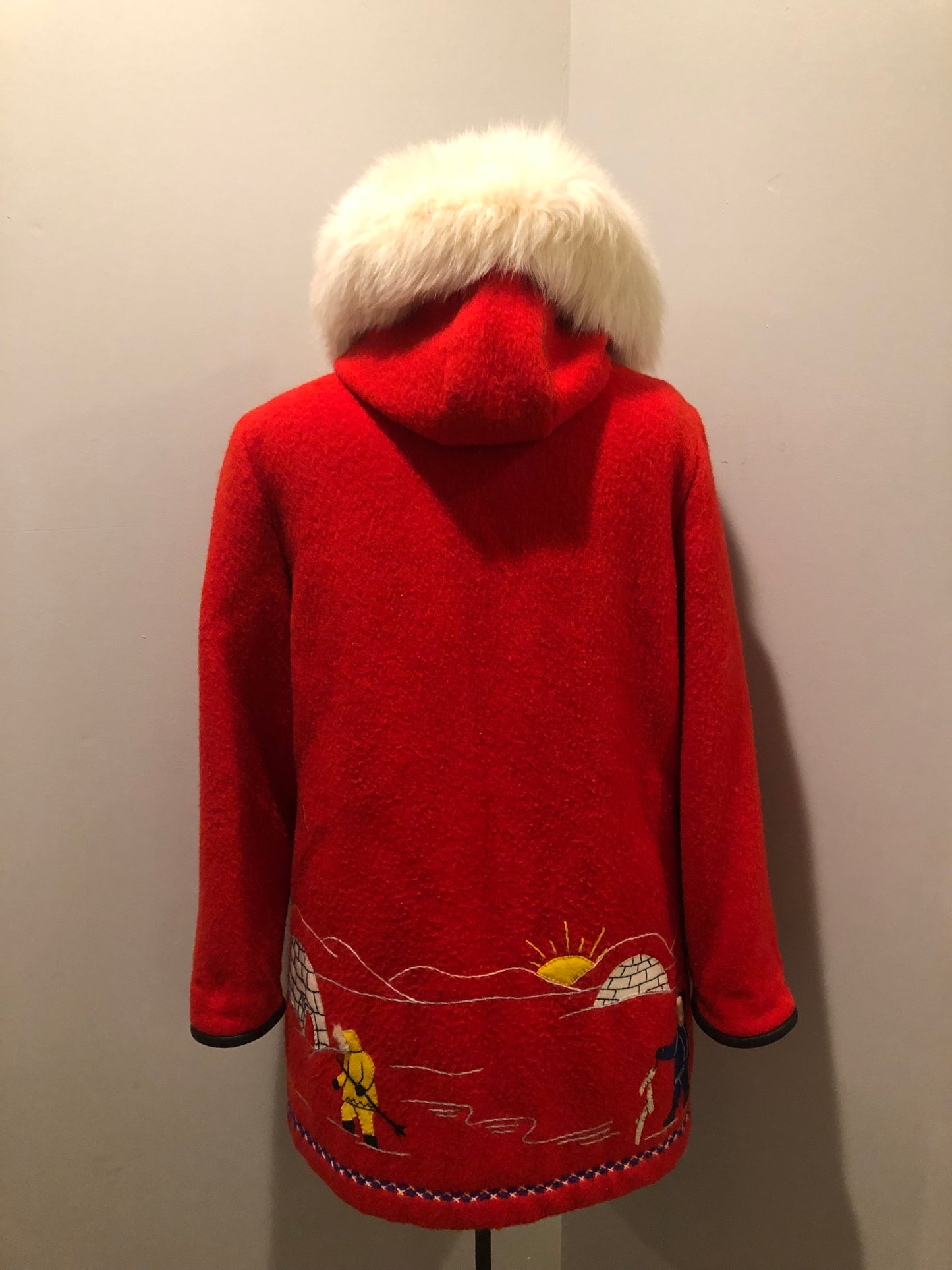 Vintage James Bay 100% virgin wool northern parka in bright red. This parka features a white fur trimmed hood, zipper closure, patch pockets, quilted lining, storm cuffs, embroidery details and northern fishing scene in felt applique. Made in Canada - Kingspier Vintage