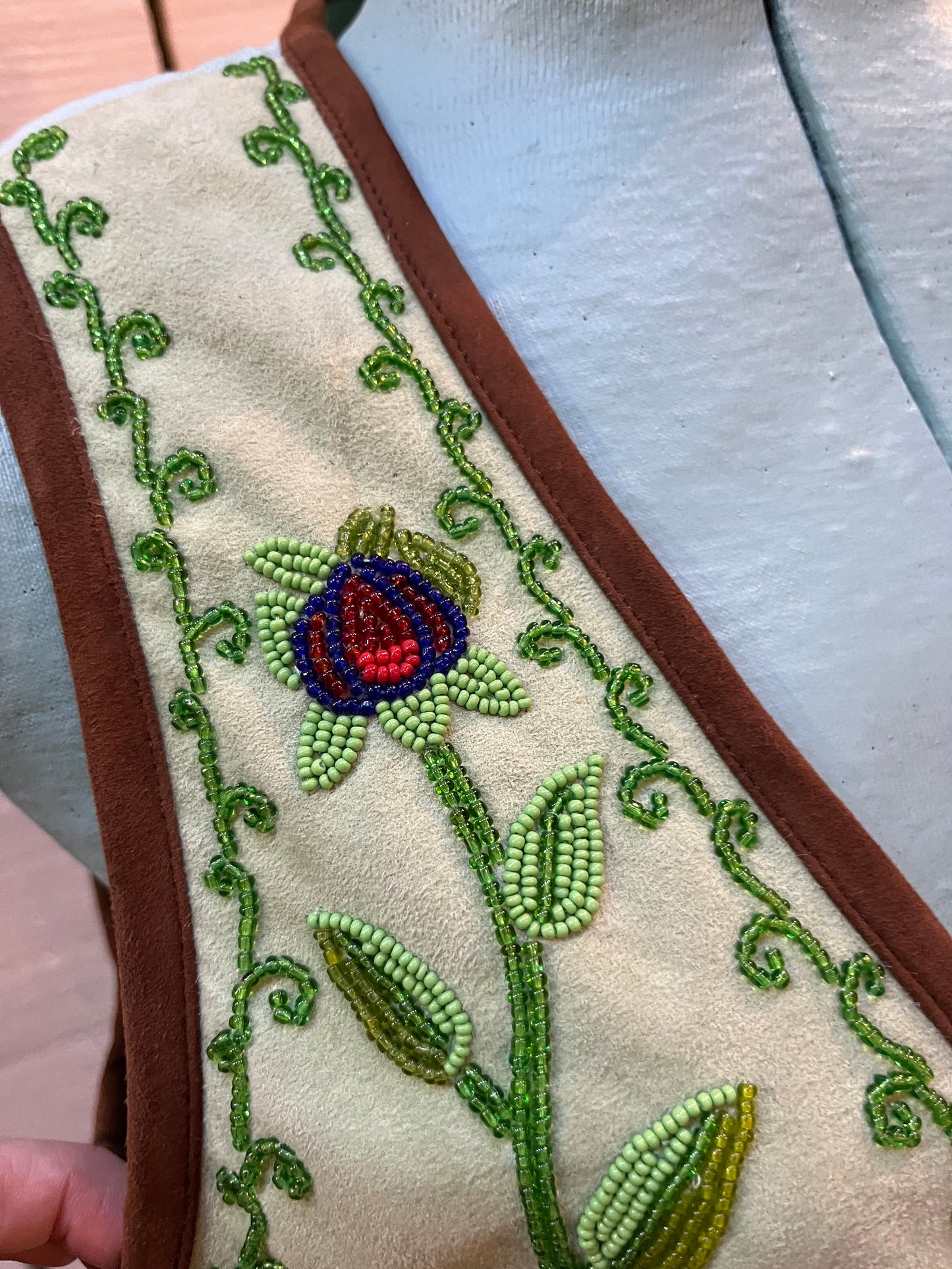 Double D Ranch light green goat suede vest with brown fringe detail, hook and eye closure, cotton/ linen back panel, satin lining and a western cowboy and desert rose design that is hand beaded.
Made in India
Size Medium