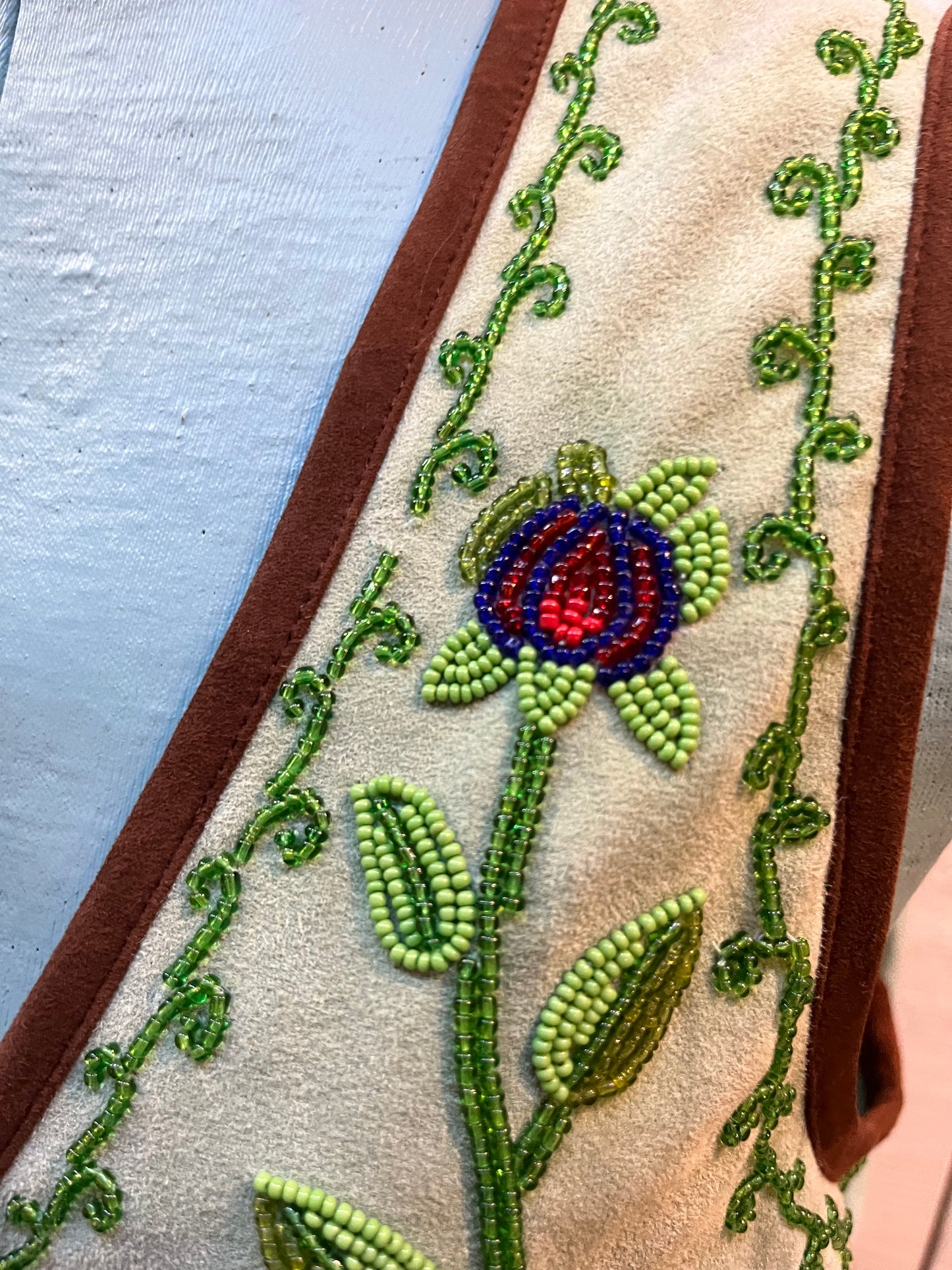 Double D Ranch light green goat suede vest with brown fringe detail, hook and eye closure, cotton/ linen back panel, satin lining and a western cowboy and desert rose design that is hand beaded.
Made in India
Size Medium