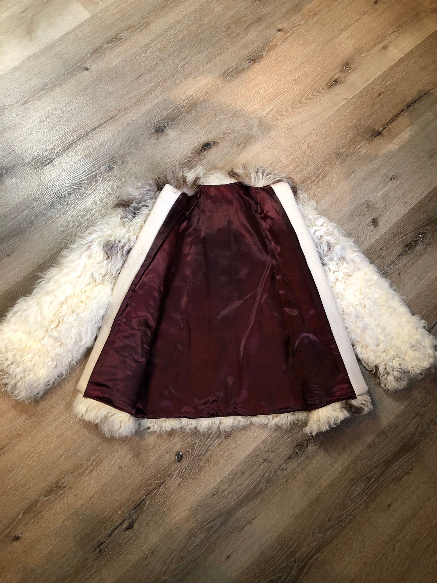 Kingspier Vintage - Vintage Mongolian sheepskin coat with soft and curly white and brown fur, pockets, pink satin lining, unique buttons and leather frog closures. Size small.