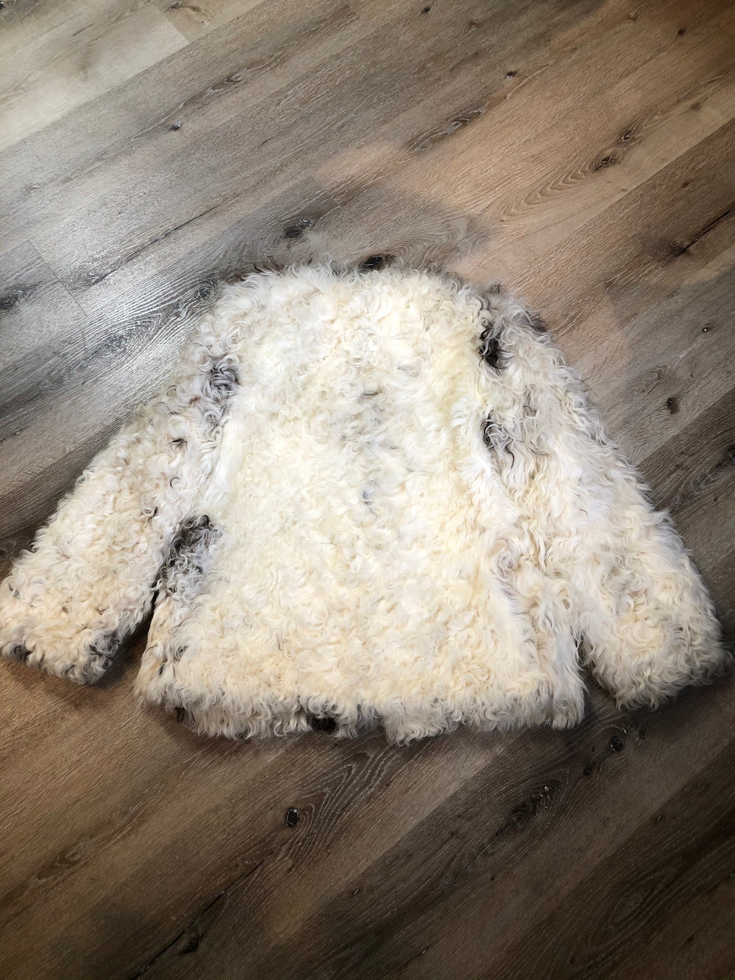 Kingspier Vintage - Vintage Mongolian sheepskin coat with soft and curly white and brown fur, pockets, pink satin lining, unique buttons and leather frog closures. Size small.