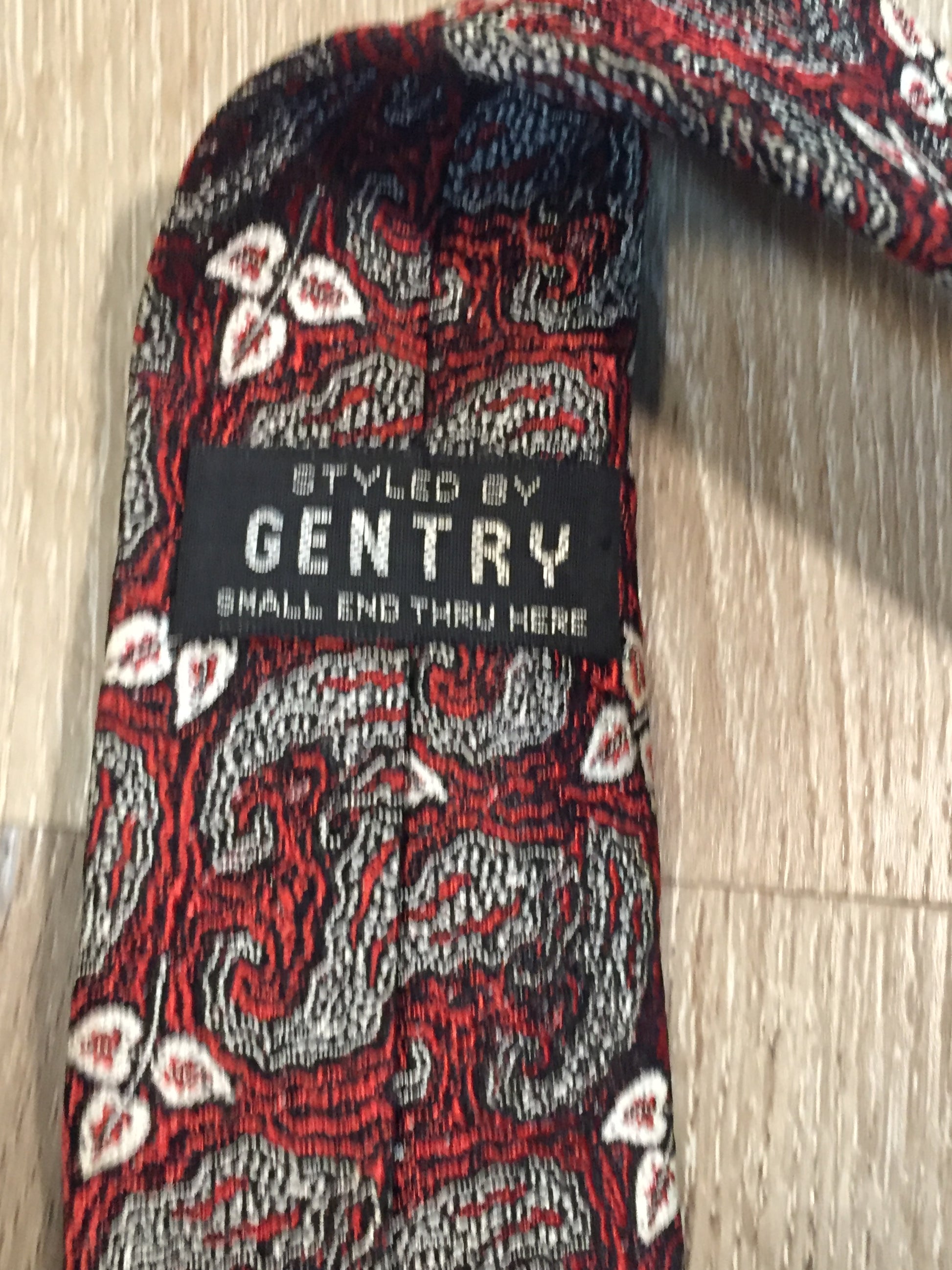 Kingspier Vintage - Gentry tie in red, white and black pattern. Fibres unknown. 
Length: 55.5” 
Width: 2.5” 
This tie is in excellent condition.