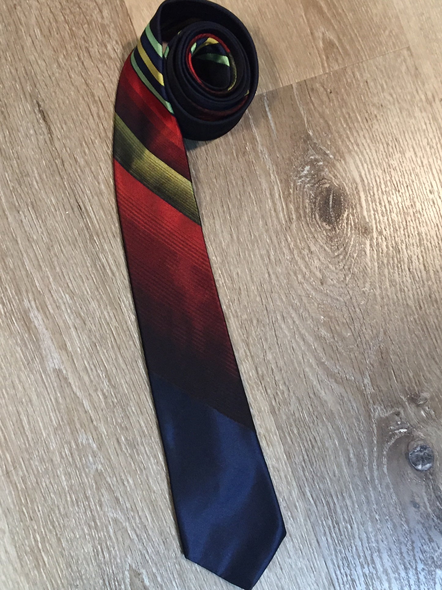 Kingspier Vintage - Playboy tie with navy, red, yellow and green design. Fibres unknown.
Length: 57.5”
Width: 2.5”
This tie is in excellent condition.