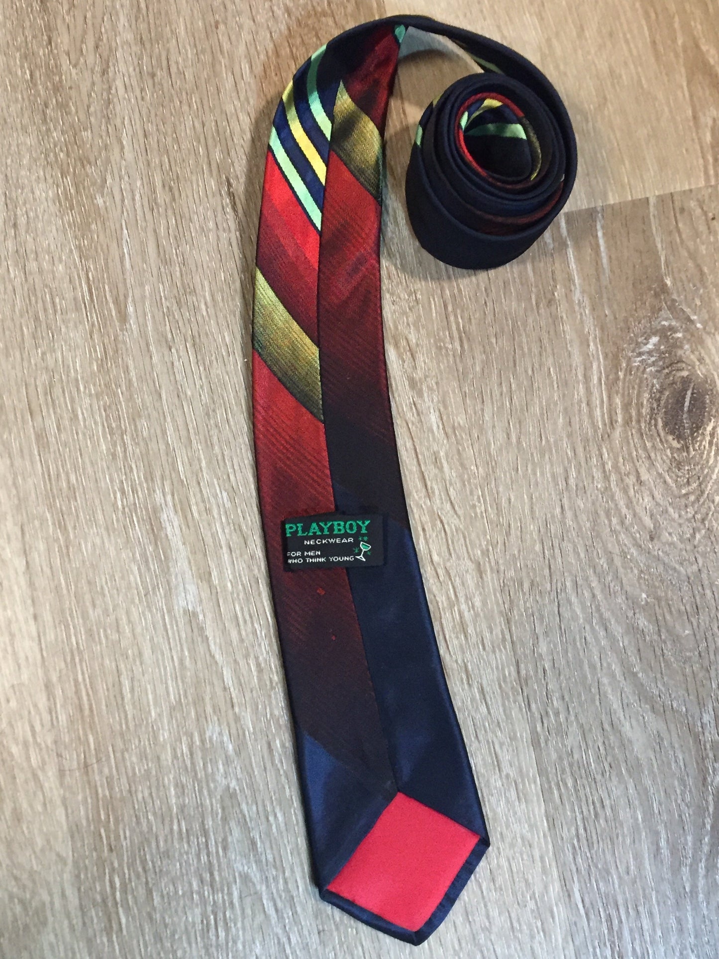 Kingspier Vintage - Playboy tie with navy, red, yellow and green design. Fibres unknown.
Length: 57.5”
Width: 2.5”
This tie is in excellent condition.