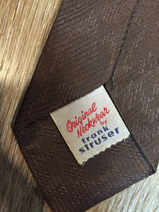Kingspier Vintage - Frank Struser Original Necktie in brown with gold starburst design. Fibres unknown.

Length: 56.6” 
Width: 2.5” 

This tie is in excellent condition.