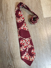 Load image into Gallery viewer, Kingspier Vintage - Van Heussen de Luxe in burgundy, red, cream and brown design on a subtle checkerboard background. Fibres unknown.

Length: 53” 
Width: 4”

This tie is in excellent condition.
