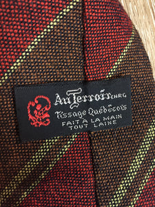 Kingspier Vintage - Au Terroira 100% wool tie with red, black, brown and green stripes. Made in Québec.

Length: 53” 
Width: 3.5”

This tie is in excellent condition.