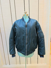 Load image into Gallery viewer, Vintage USAF Cobles Clothing Division Blue Flyer’s Man Intermediate MA. 1 Jacket. Based on original MIL-J-8279E.

100% nylon shell with polyester fill, blaze orange safety lining, zipper closure, two front slash pockets and a pocket on the left arm.

Size Medium
