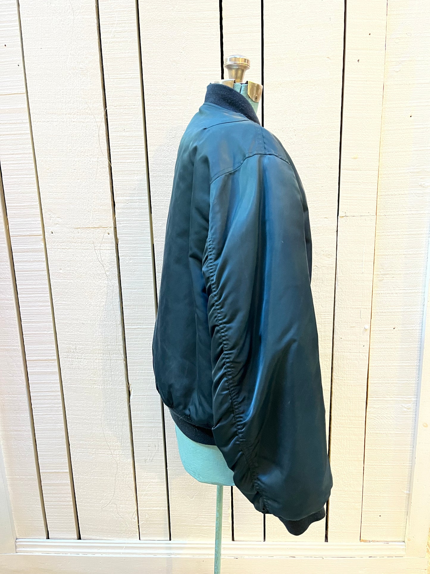 Vintage USAF Cobles Clothing Division Blue Flyer’s Man Intermediate MA. 1 Jacket. Based on original MIL-J-8279E.
100% nylon shell with polyester fill, blaze orange safety lining, zipper closure, two front slash pockets and a pocket on the left arm.
Size Medium
