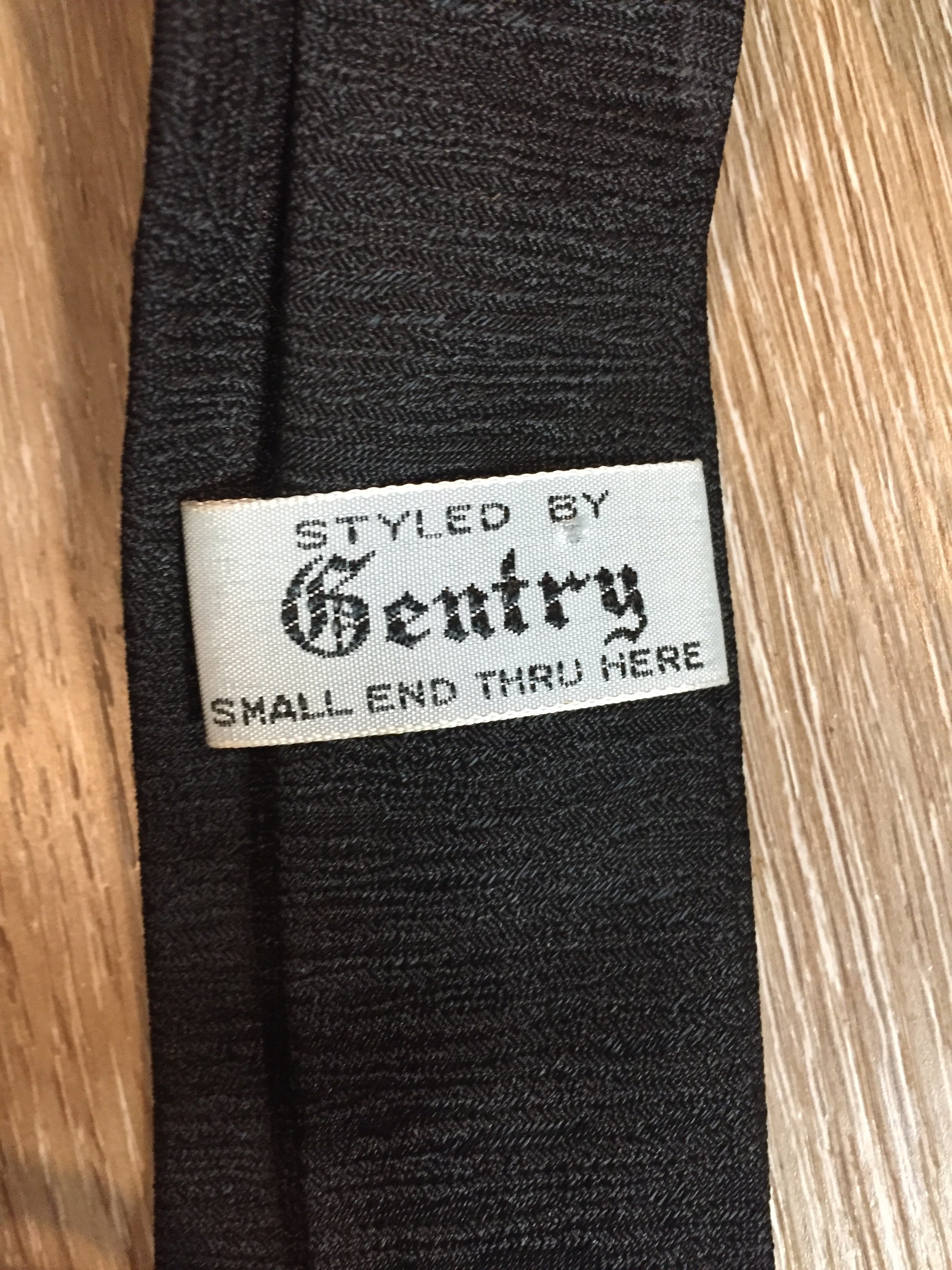 Kingspier Vintage - Gentry tie in black with red, white, yellow diamond motif. Fibres unknown.
Length: 52”
Width: 2.25” 
This tie is in excellent condition.