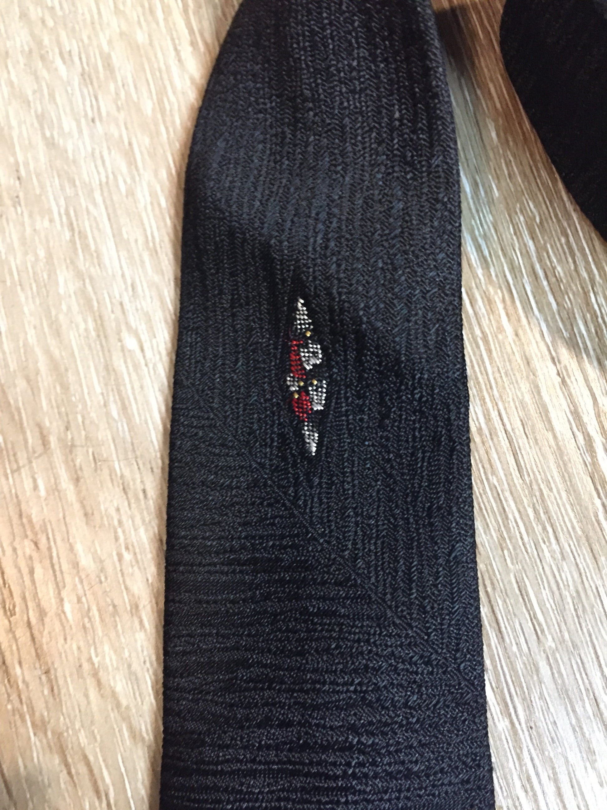 Kingspier Vintage - Gentry tie in black with red, white, yellow diamond motif. Fibres unknown.
Length: 52”
Width: 2.25” 
This tie is in excellent condition.