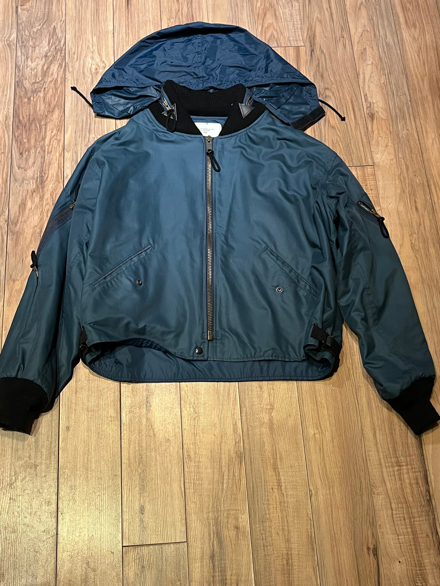 Vintage 1994 RCAF W8473-3ANON/01-PE Blue Bomber Jacket with zipper closure, multiple zip pockets and packaway hood.
Chest 52”