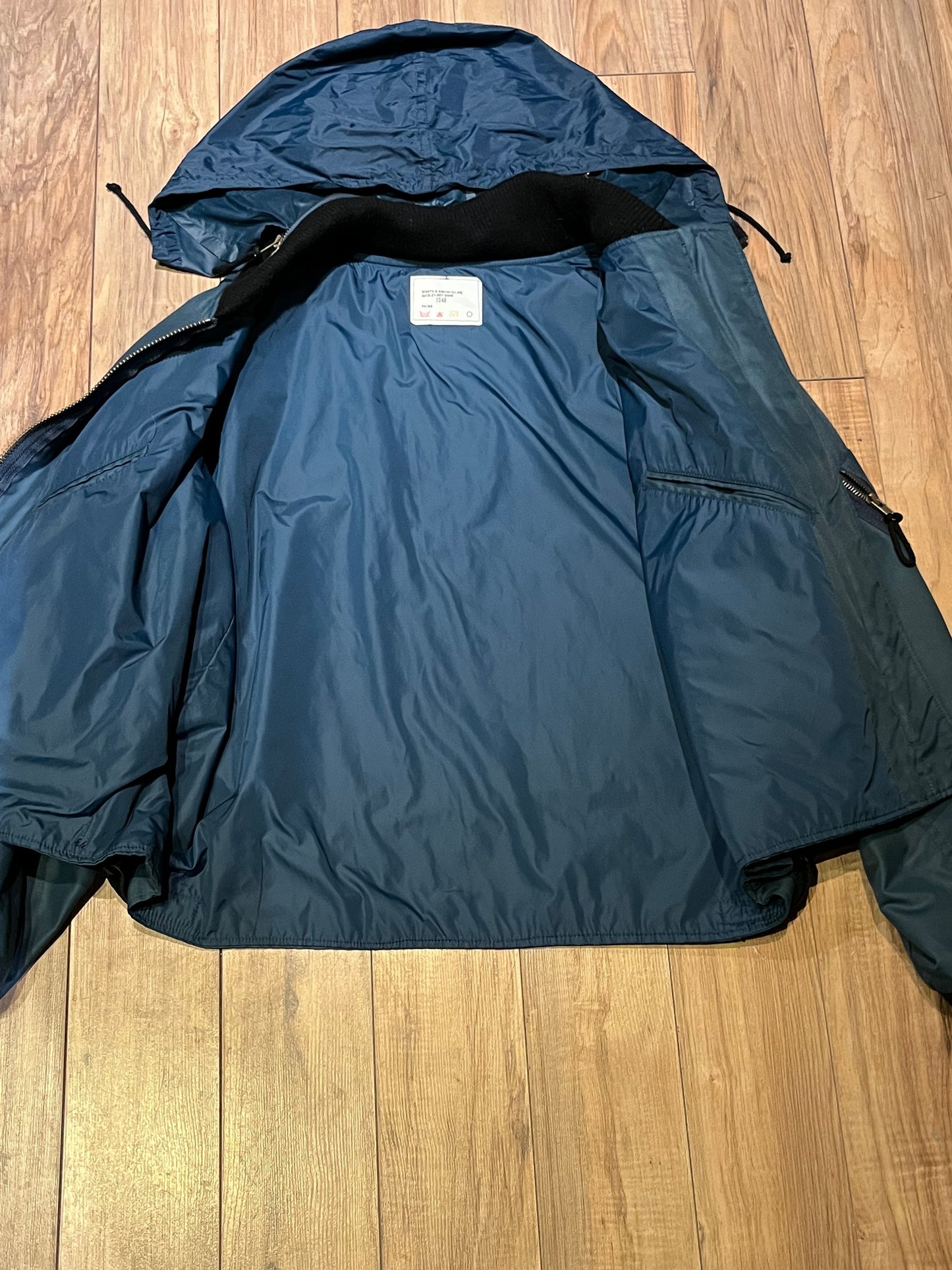 Vintage 1994 RCAF W8473-3ANON/01-PE Blue Bomber Jacket with zipper closure, multiple zip pockets and packaway hood.
Chest 52”