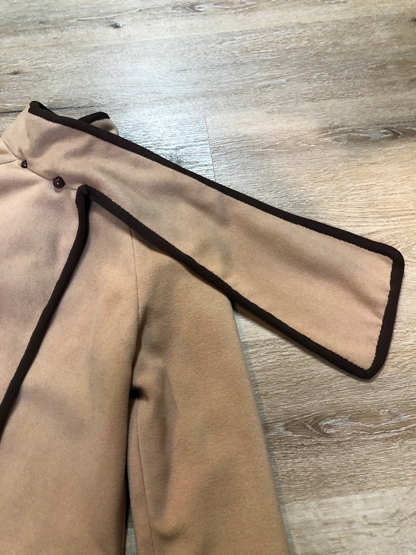 Kingspier Vintage - Handmade camel coloured cashmere cape with sleeves, attached scarf, patch pockets, two button closure at the collar and a full lining.
