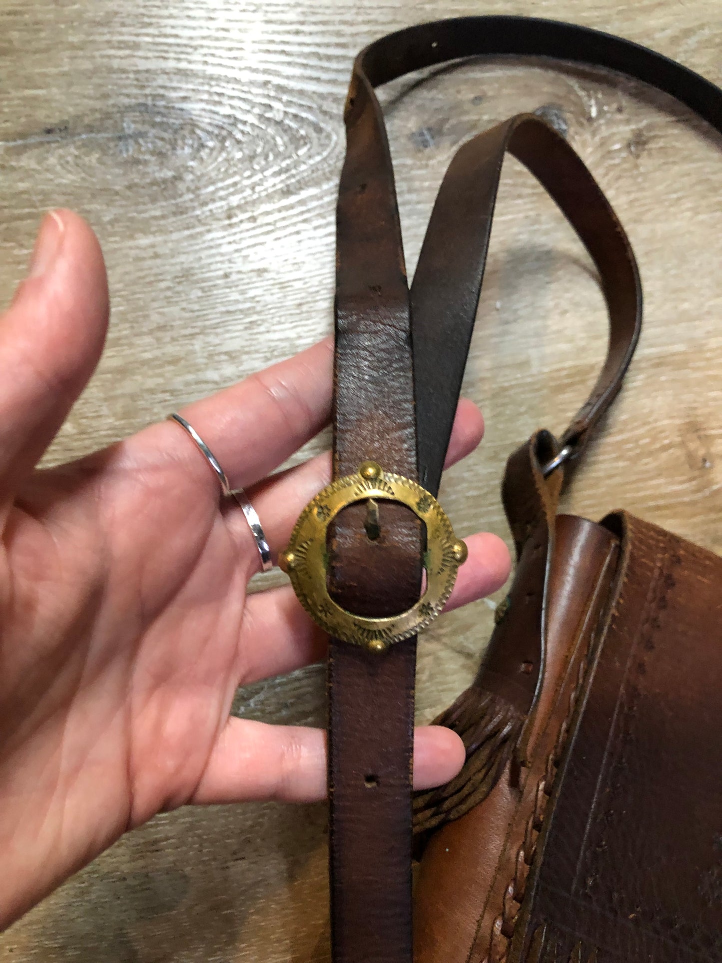 Vintage full grain brown leather crossbody bag with leather fringe, hand tooled designs, brass hardware, flap closure, two interior compartments and adjustable shoulder strap. Bag is scented with patchouli - Kingspier Vintage