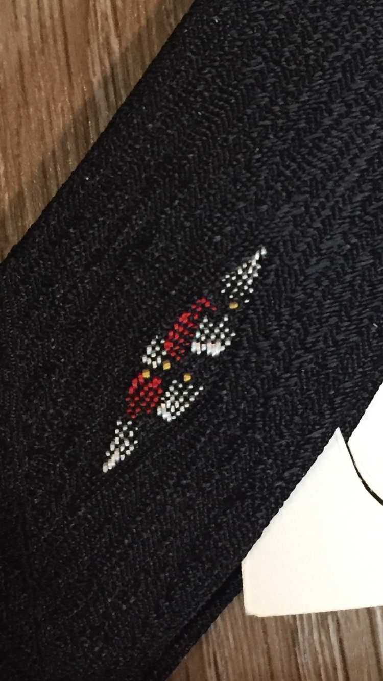 Kingspier Vintage - Gentry tie in black with red, white, yellow diamond motif. Fibres unknown.
Length: 52”
Width: 2.25” 
This tie is in excellent condition.