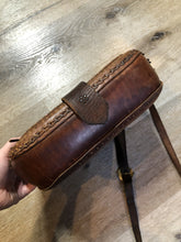 Load image into Gallery viewer, Vintage full grain brown leather crossbody bag with leather fringe, hand tooled designs, brass hardware, flap closure, two interior compartments and adjustable shoulder strap.  Bag is scented with patchouli - Kingspier Vintage
