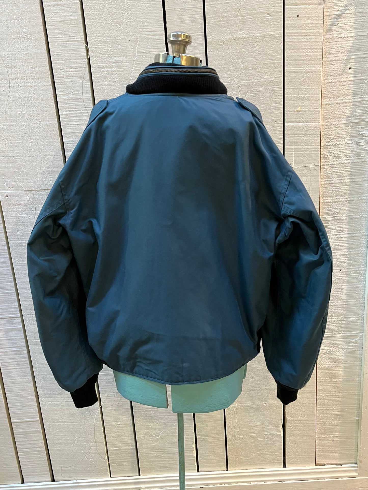 Vintage 1994 RCAF W8473-3ANON/01-PE Blue Bomber Jacket with zipper closure, multiple zip pockets and packaway hood.
Chest 52”