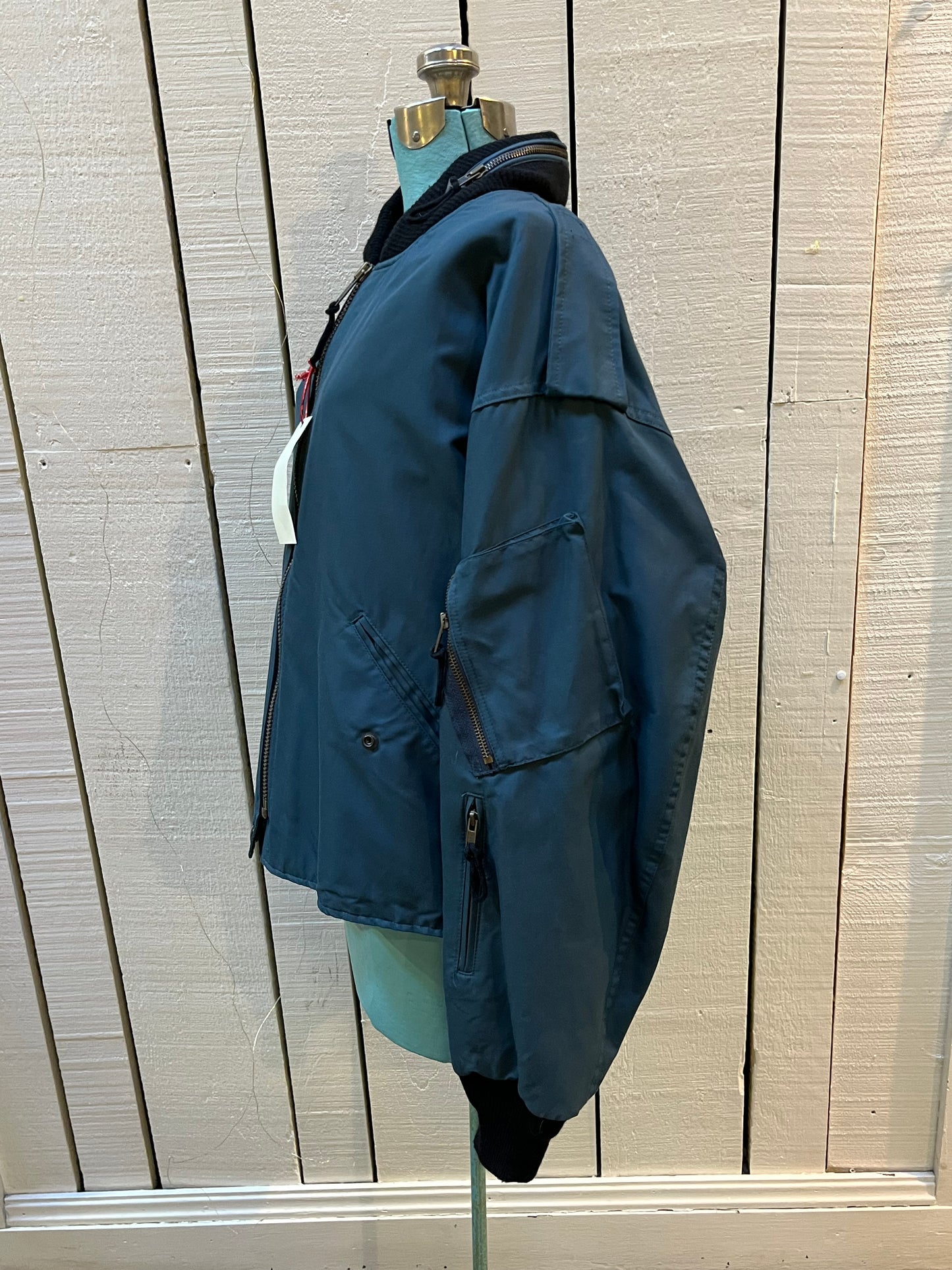 Vintage 1994 RCAF W8473-3ANON/01-PE Blue Bomber Jacket with zipper closure, multiple zip pockets and packaway hood.
Chest 52”