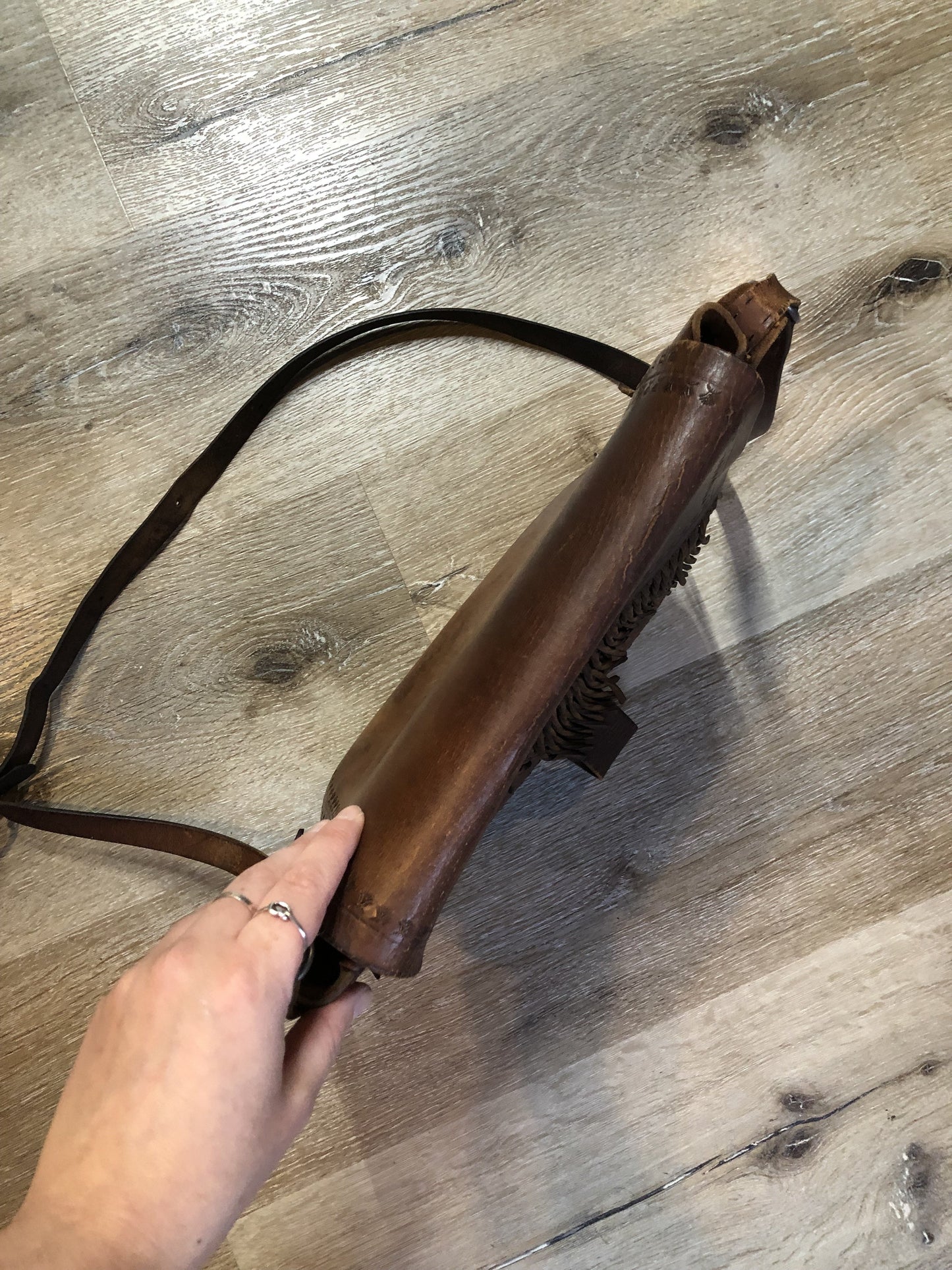 Vintage full grain brown leather crossbody bag with leather fringe, hand tooled designs, brass hardware, flap closure, two interior compartments and adjustable shoulder strap. Bag is scented with patchouli - Kingspier Vintage