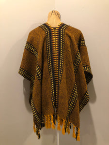 Kingspier Vintage - Vintage wool poncho with yellow, orange and brown designs and tassels on the bottom