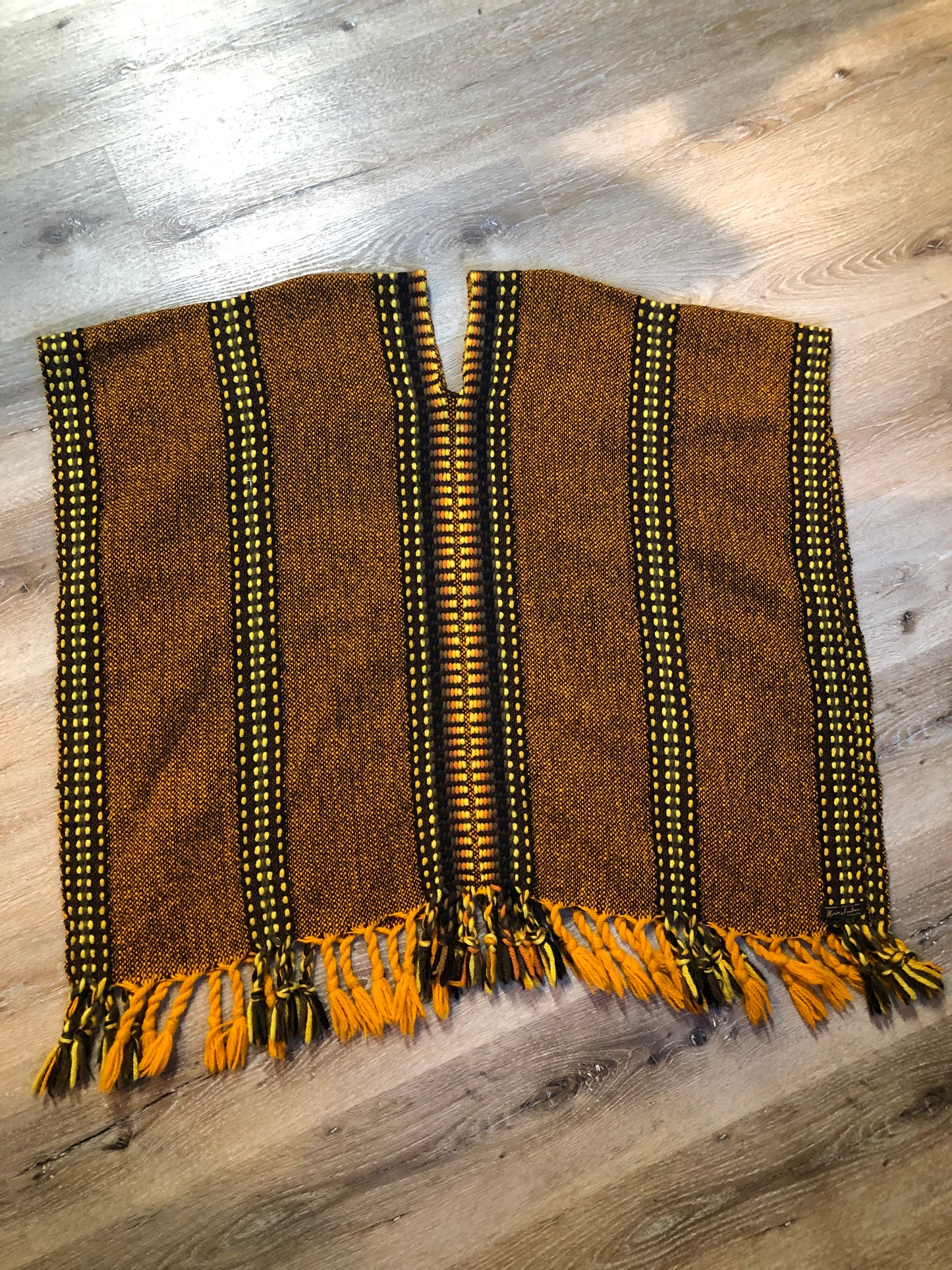 Kingspier Vintage - Vintage wool poncho with yellow, orange and brown designs and tassels on the bottom
