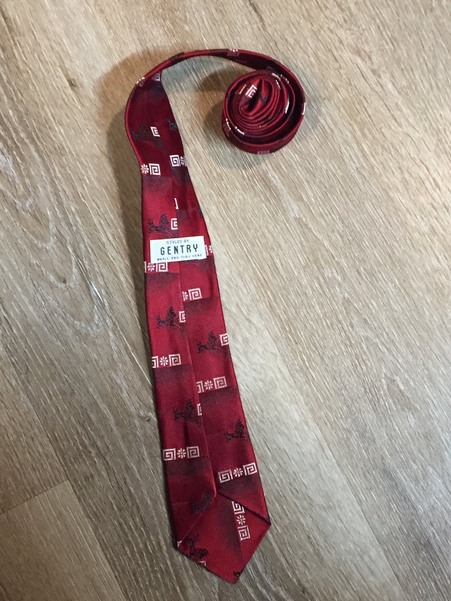 Kingspier Vintage - Gentry tie with red, black and white design. Fibres unknown.
Length: 55”
Width: 3” 
This tie is in excellent condition.