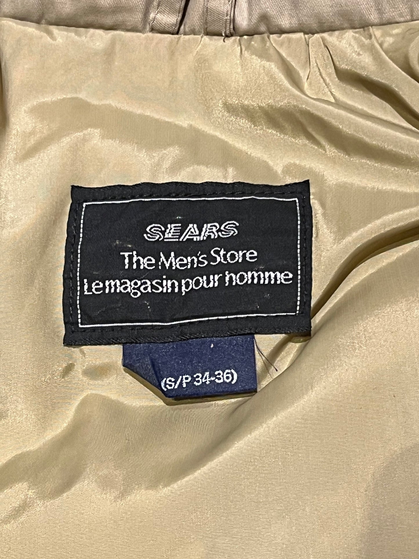 Vintage Sears “The Mens Store” beige down-filled parka (60% duck down/ 40% waterfowl feather) with cotton/nylon blend shell, zipper and button closures, two hand-warmer pockets, two flap pockets, two inside zip pockets, hood with fur trim and storm cuffs.
Made in Canada
Size Small 34-36